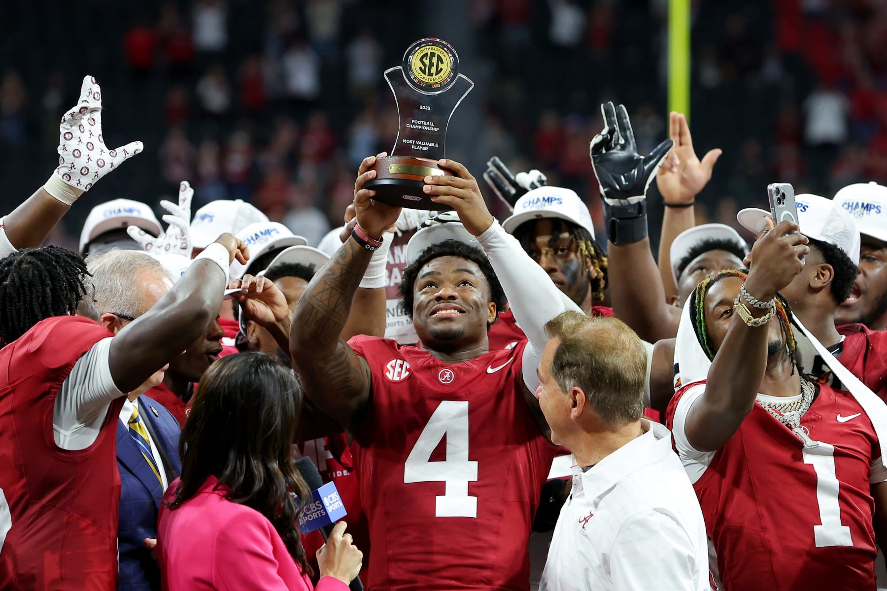ATLANTA, GEORGIA - DECEMBER 02: Jalen Milroe #4 of the Alabama Crimson Tide celebrates with the MVP trophy after defeating the Georgia Bulldogs 27-24 in the SEC Championship at Mercedes-Benz Stadium on December 02, 2023 in Atlanta, Georgia. (Photo by Kevin C. Cox/Getty Images)