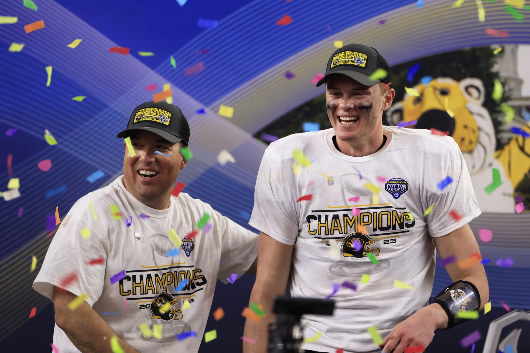 ARLINGTON, TEXAS - DECEMBER 29: Head coach Eliah Drinkwitz and Brady Cook #12 of the Missouri Tigers celebrate after defeating the Ohio State Buckeyes 14-3 in the Goodyear Cotton Bowl at AT&T Stadium on December 29, 2023 in Arlington, Texas. (Photo by Ron Jenkins/Getty Images)