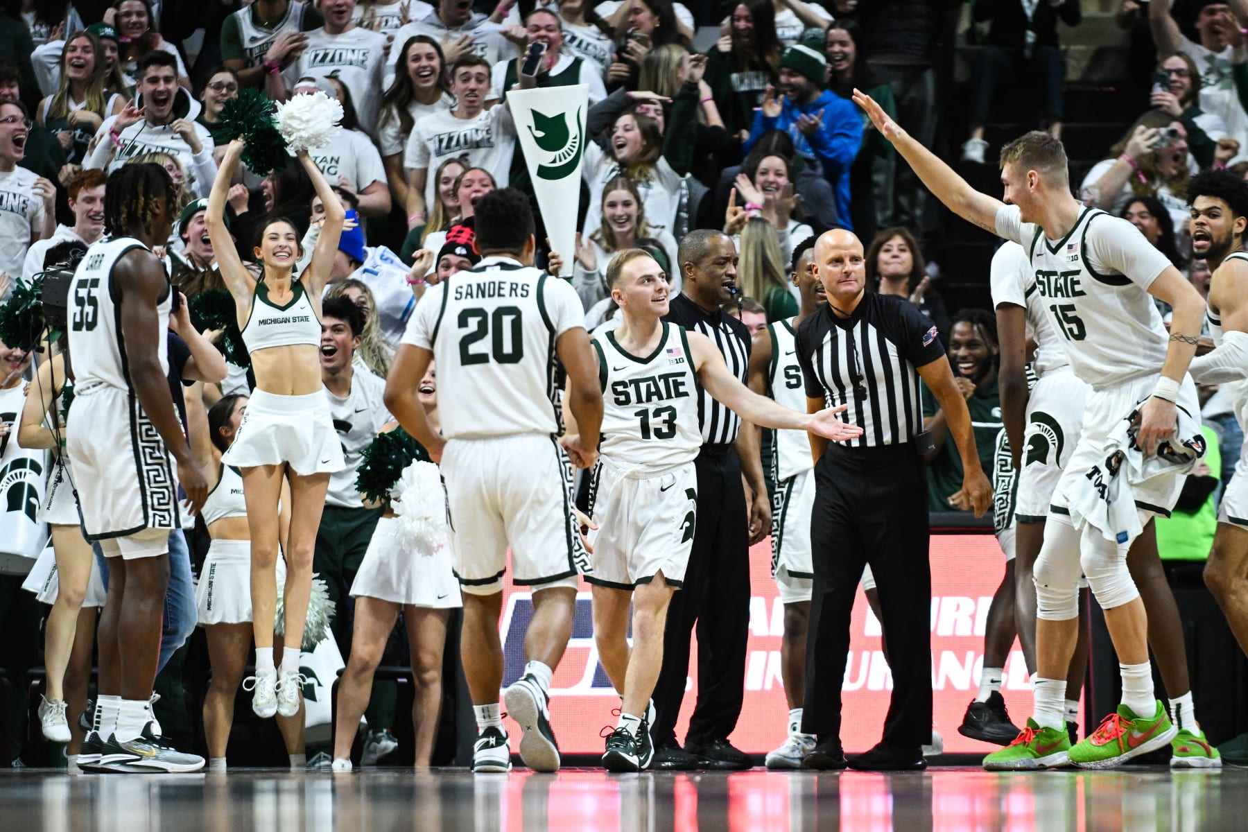 EAST LANSING, MI - JANUARY 14: Michigan State Spartans guard Steven Izzo (13) gets congratulated by teammates after scoring the first points of his career during a college basketball game between the Michigan State Spartans and the Rutgers Scarlet Knights on January 14, 2024, at the Breslin Center in East Lansing, MI. (Photo by Adam Ruff/Icon Sportswire via Getty Images)