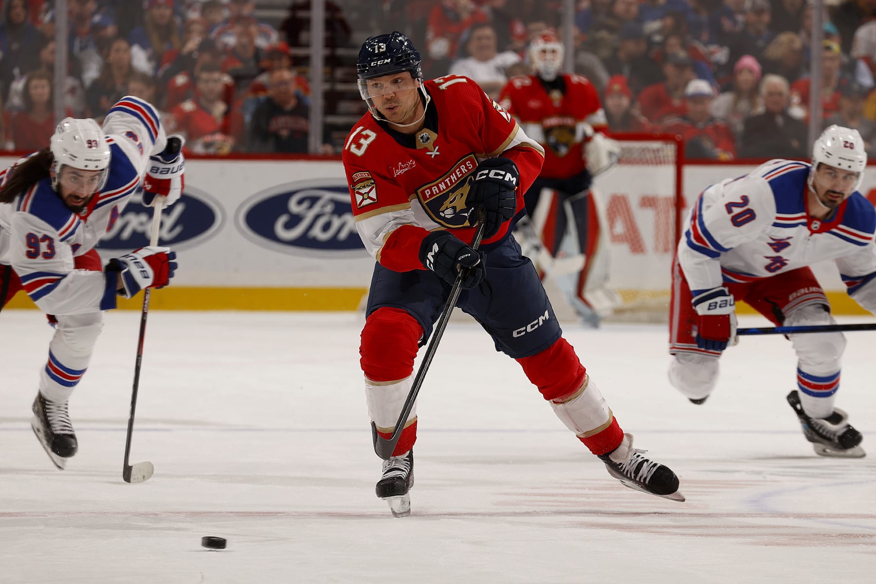 SUNRISE, FLORIDA - DECEMBER 29: Sam Reinhart #13 of the Florida Panthers skates for possession against the New York Rangers at the Amerant Bank Arena on December 29, 2023 in Sunrise, Florida. (Photo by Eliot J. Schechter/NHLI via Getty Images)