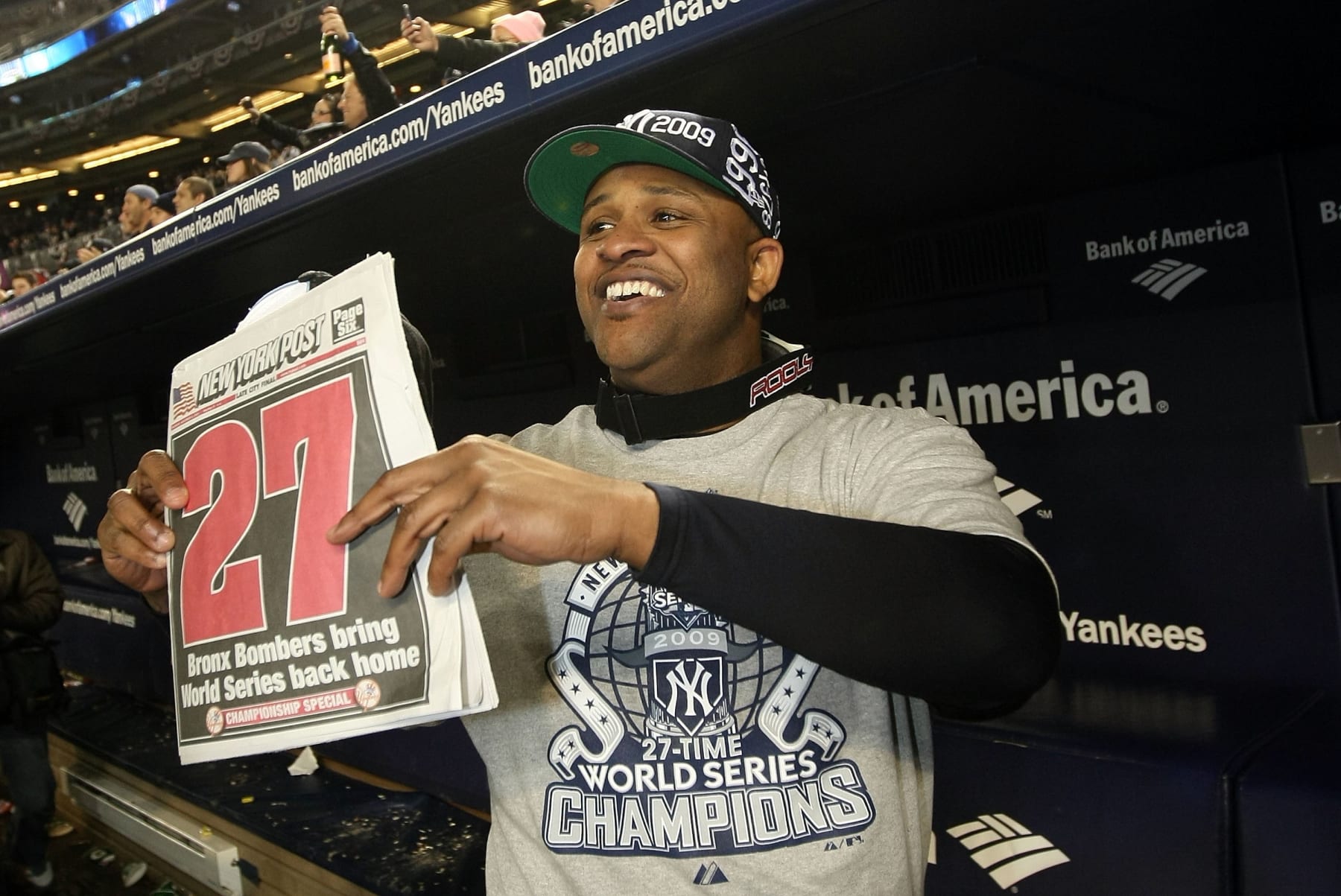 NEW YORK - NOVEMBER 04: C.C. Sabathia of the New York Yankees celebrates in the dugout with a copy of the New York Post after their 7-3 win against the Philadelphia Phillies in Game Six of the 2009 MLB World Series at Yankee Stadium on November 4, 2009 in the Bronx borough of New York City. (Photo by Nick Laham/Getty Images)