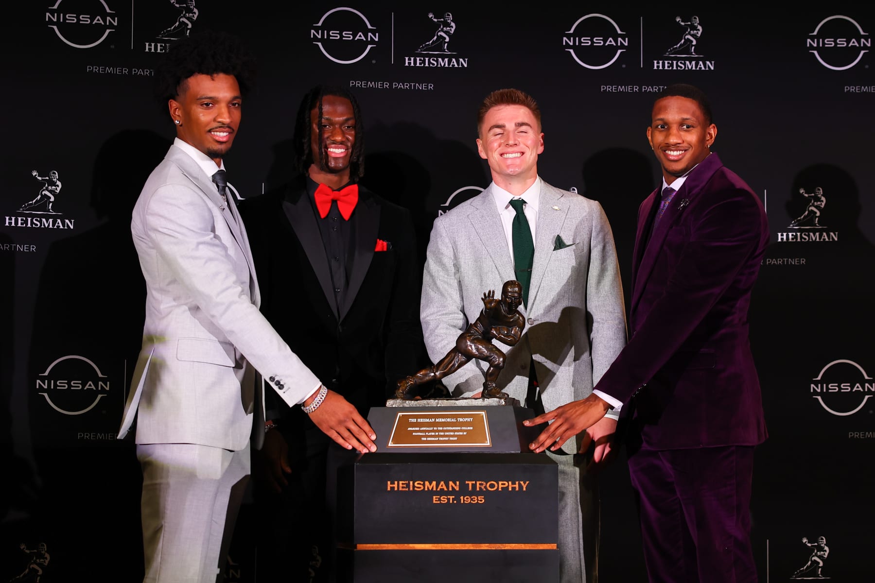 Jayden Daniels (left), Bo Nix (middle right) and Michael Penix Jr. (right) with Marvin Harrison Jr. (middle left)