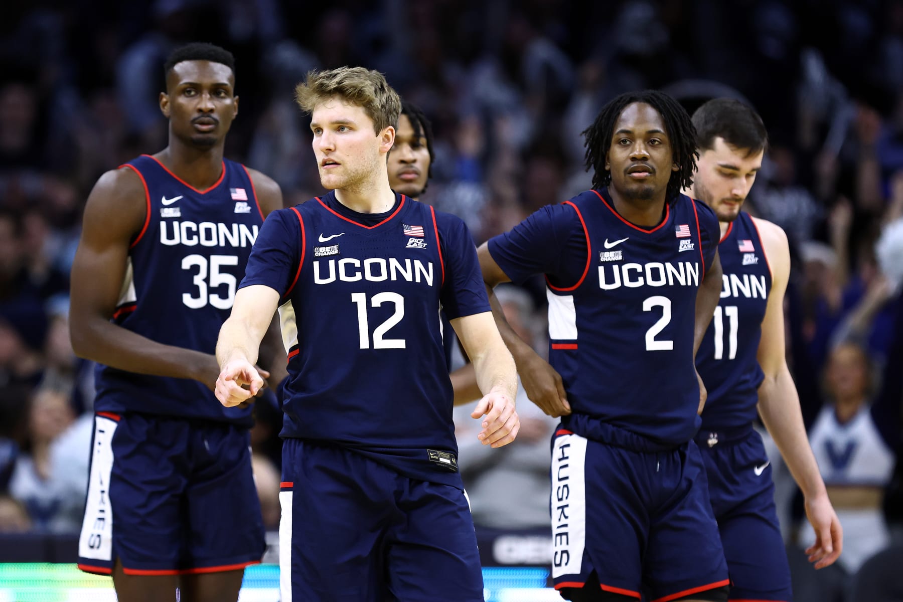 PHILADELPHIA, PENNSYLVANIA - JANUARY 20: Cam Spencer #12 of the Connecticut Huskies (C) looks on with teammates during the second half against the Villanova Wildcats at the Wells Fargo Center on January 20, 2024 in Philadelphia, Pennsylvania. (Photo by Tim Nwachukwu/Getty Images)