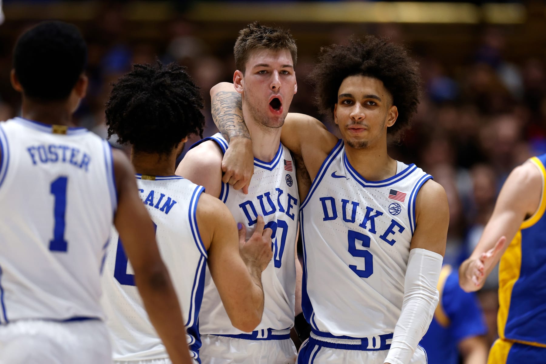 DURHAM, NORTH CAROLINA - JANUARY 20: Jared McCain #0 and Tyrese Proctor #5 try to calm Kyle Filipowski #30 of the Duke Blue Devils following his foul during the second half of the game against the Pittsburgh Panthers at Cameron Indoor Stadium on January 20, 2024 in Durham, North Carolina. Pitt won 80-76. (Photo by Lance King/Getty Images)