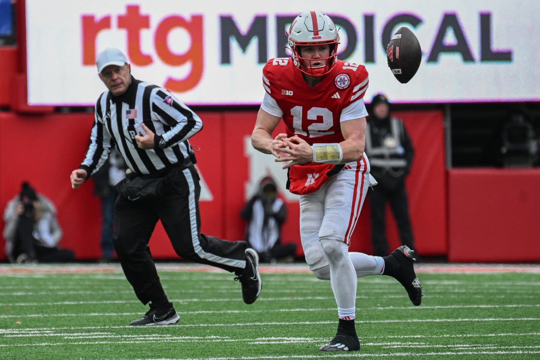 LINCOLN, NEBRASKA - NOVEMBER 24: Quarterback Chubba Purdy #12 of the Nebraska Cornhuskers fumbles against the Iowa Hawkeyes in the fourth quarter at Memorial Stadium on November 24, 2023 in Lincoln, Nebraska. (Photo by Steven Branscombe/Getty Images)