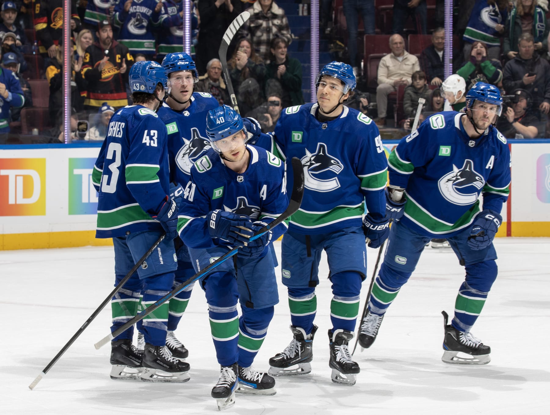 VANCOUVER, CANADA - JANUARY 18: Elias Pettersson #40 of the Vancouver Canucks skates back to the bench to celebrate his goal with teammates during the first period of their NHL game against the Arizona Coyotes at Rogers Arena on January 18, 2024 in Vancouver, British Columbia, Canada. (Photo by Jeff Vinnick/NHLI via Getty Images)