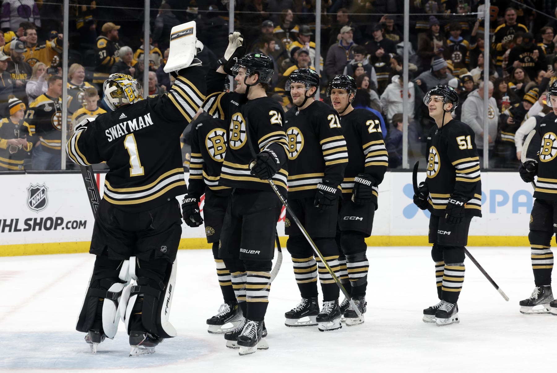 BOSTON, MA - JANUARY 22: Teammates flock ro Boston Bruins goalie Jeremy Swayman (1) after a game between the Boston Bruins and the Winnipeg Jets on January 22, 2024, at TD Garden in Boston, Massachusetts. (Photo by Fred Kfoury III/Icon Sportswire via Getty Images)