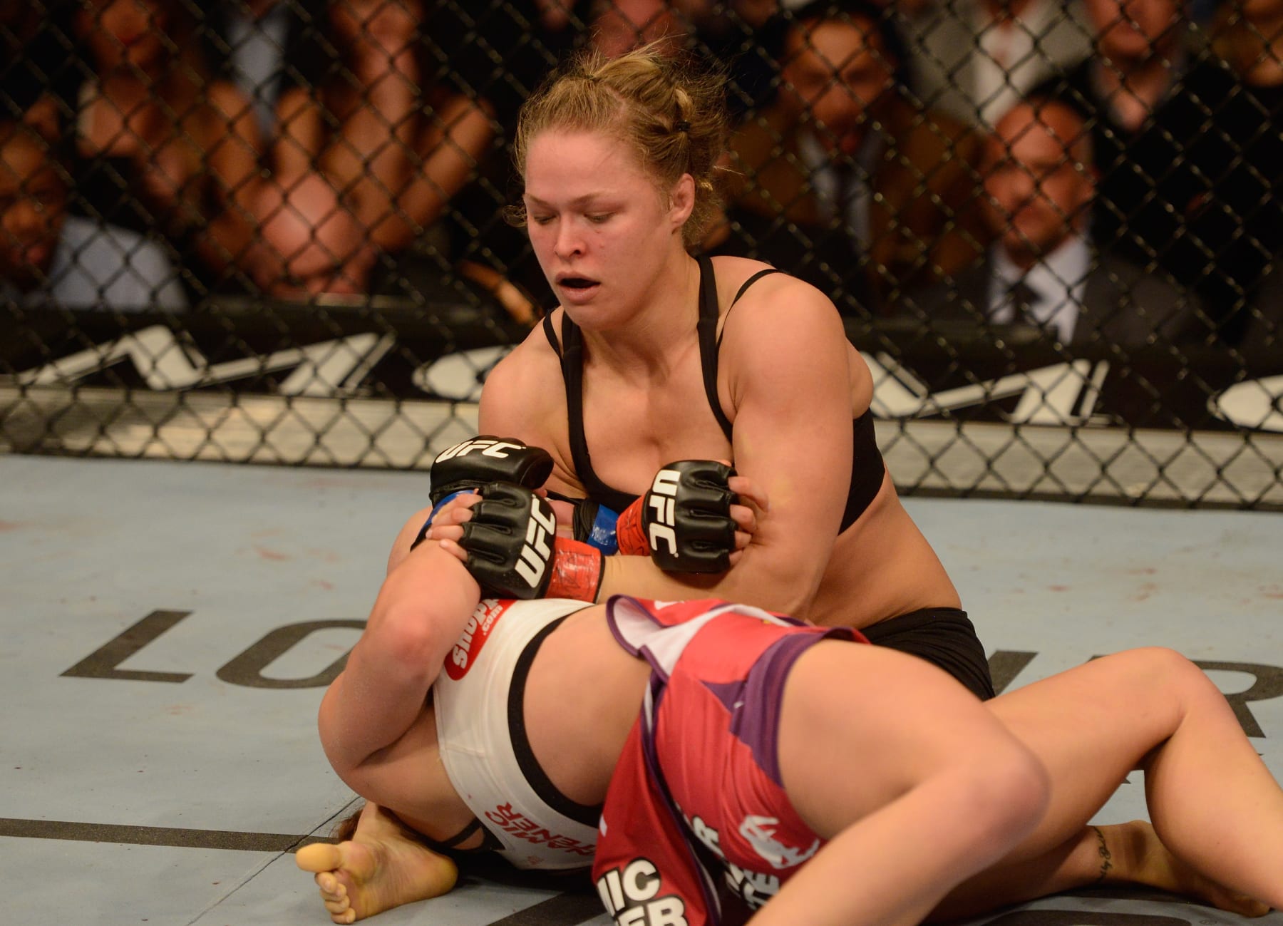 LAS VEGAS, NV - DECEMBER 28: Ronda Rousey (top) attempts to submit Miesha Tate in their UFC women's bantamweight championship bout during the UFC 168 event at the MGM Grand Garden Arena on December 28, 2013 in Las Vegas, Nevada. (Photo by Donald Miralle/Zuffa LLC/Zuffa LLC via Getty Images)