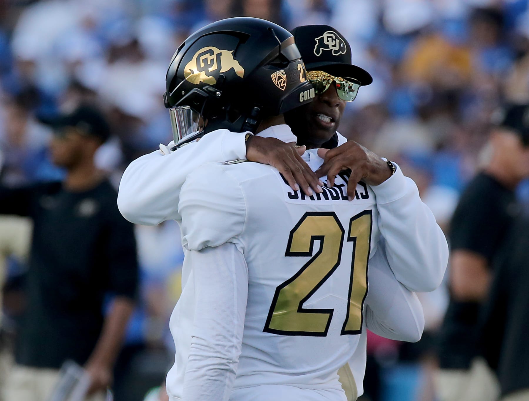 Pasadena, CA - Colorado coach Deon Sanders hugs his son, Colorado quarterback Shedeur Sander, before the game against UCLA at at the Rose Bowl in Pasadena on Saturday, Oct. 28, 2023. (Luis Sinco / Los Angeles Times via Getty Images)