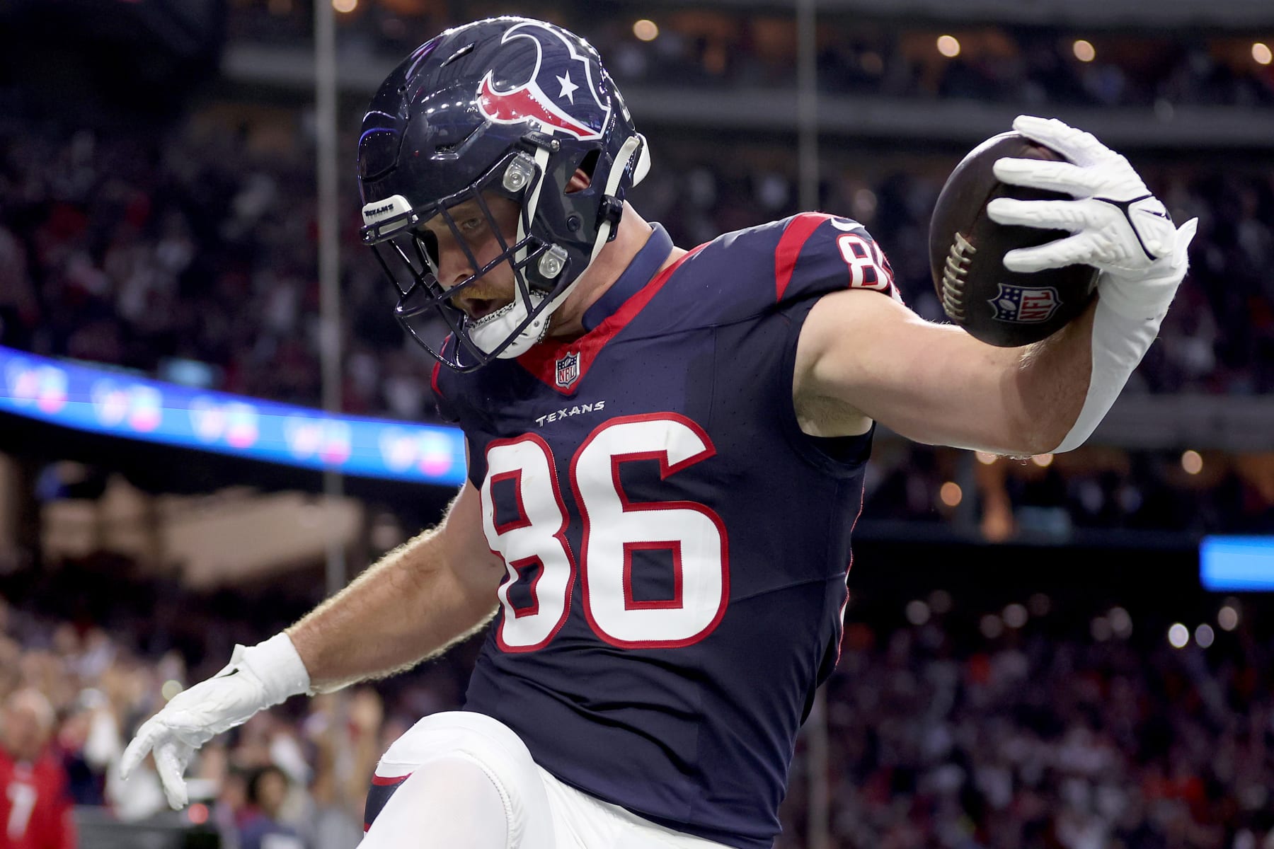 HOUSTON, TEXAS - JANUARY 13: Dalton Schultz #86 of the Houston Texans celebrates after scoring a 37 yard touchdown against the Cleveland Browns during the second quarter in the AFC Wild Card Playoffs at NRG Stadium on January 13, 2024 in Houston, Texas. (Photo by Tim Warner/Getty Images)