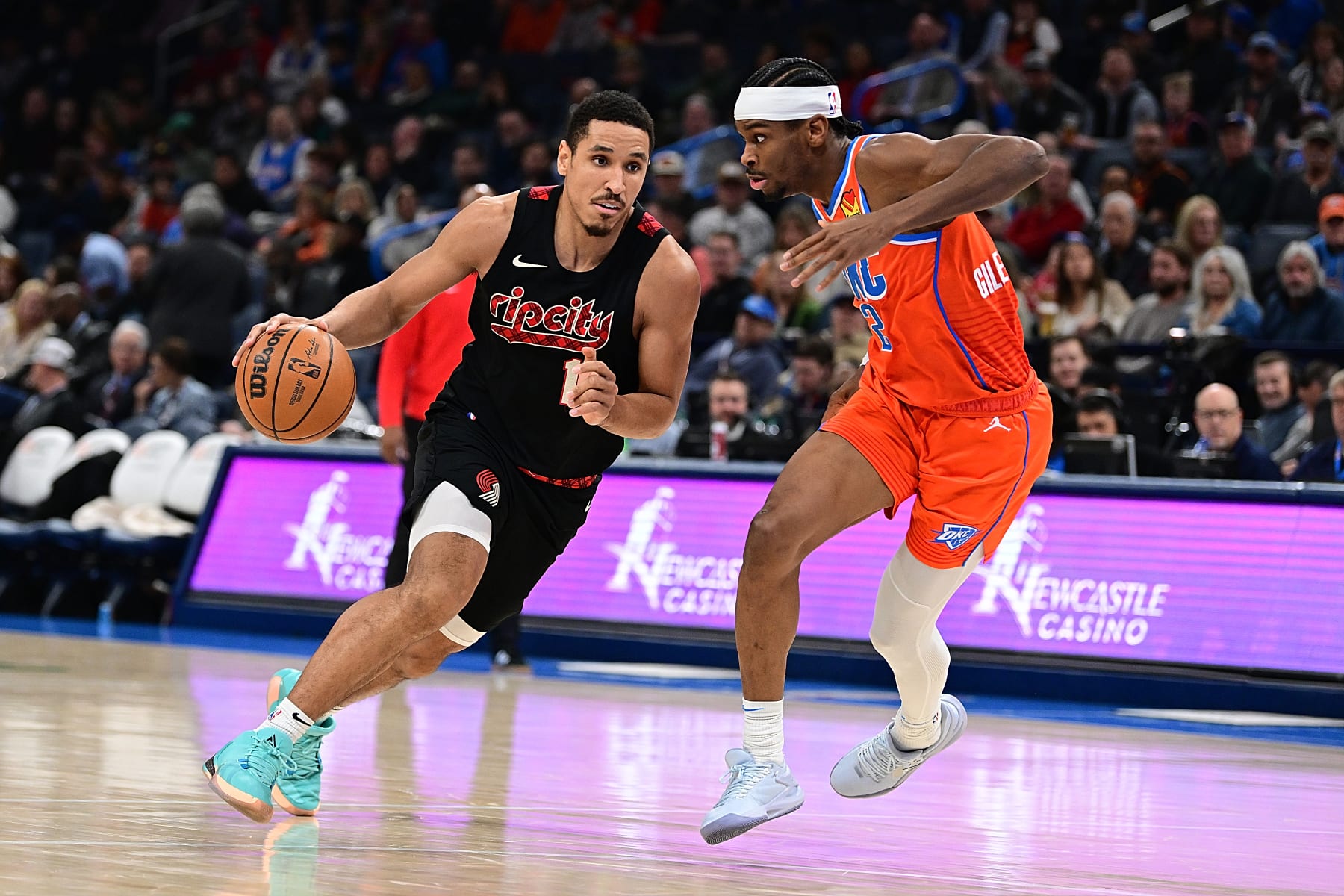 OKLAHOMA CITY, OKLAHOMA - JANUARY 23: Malcolm Brogdon #11 of the Portland Trail Blazers handles the ball during the second half against Shai Gilgeous-Alexander #2 of the Oklahoma City Thunder at Paycom Center on January 23, 2024 in Oklahoma City, Oklahoma. NOTE TO USER: User expressly acknowledges and agrees that, by downloading and or using this Photograph, user is consenting to the terms and conditions of the Getty Images License Agreement. (Photo by Joshua Gateley/Getty Images)