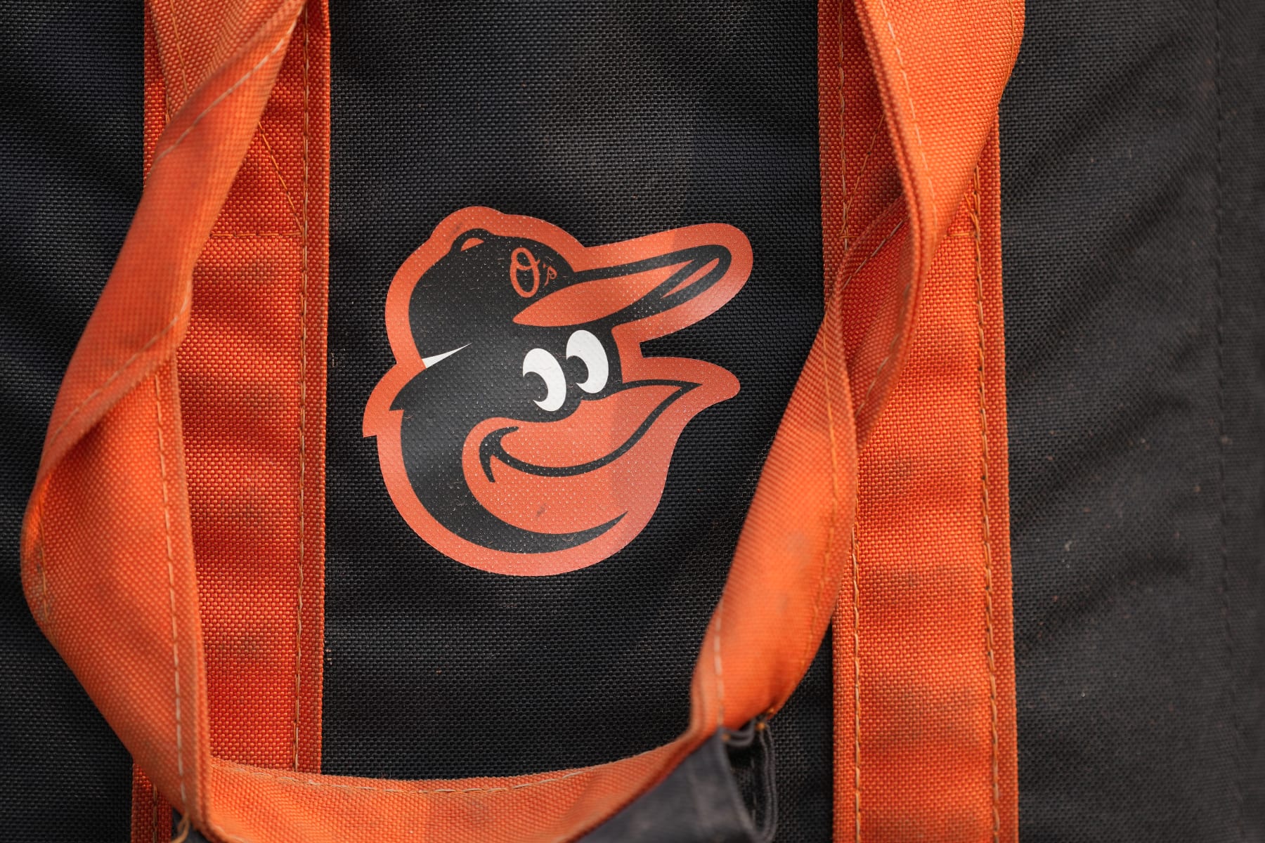BALTIMORE, MD - JULY 17:  The Baltimore Orioles logo on a baseball bag on the field before a baseball game against the Los Angeles Dodgers at Oriole Park at Camden Yards on July 17, 2023 in Baltimore, Maryland.  (Photo by Mitchell Layton/Getty Images)