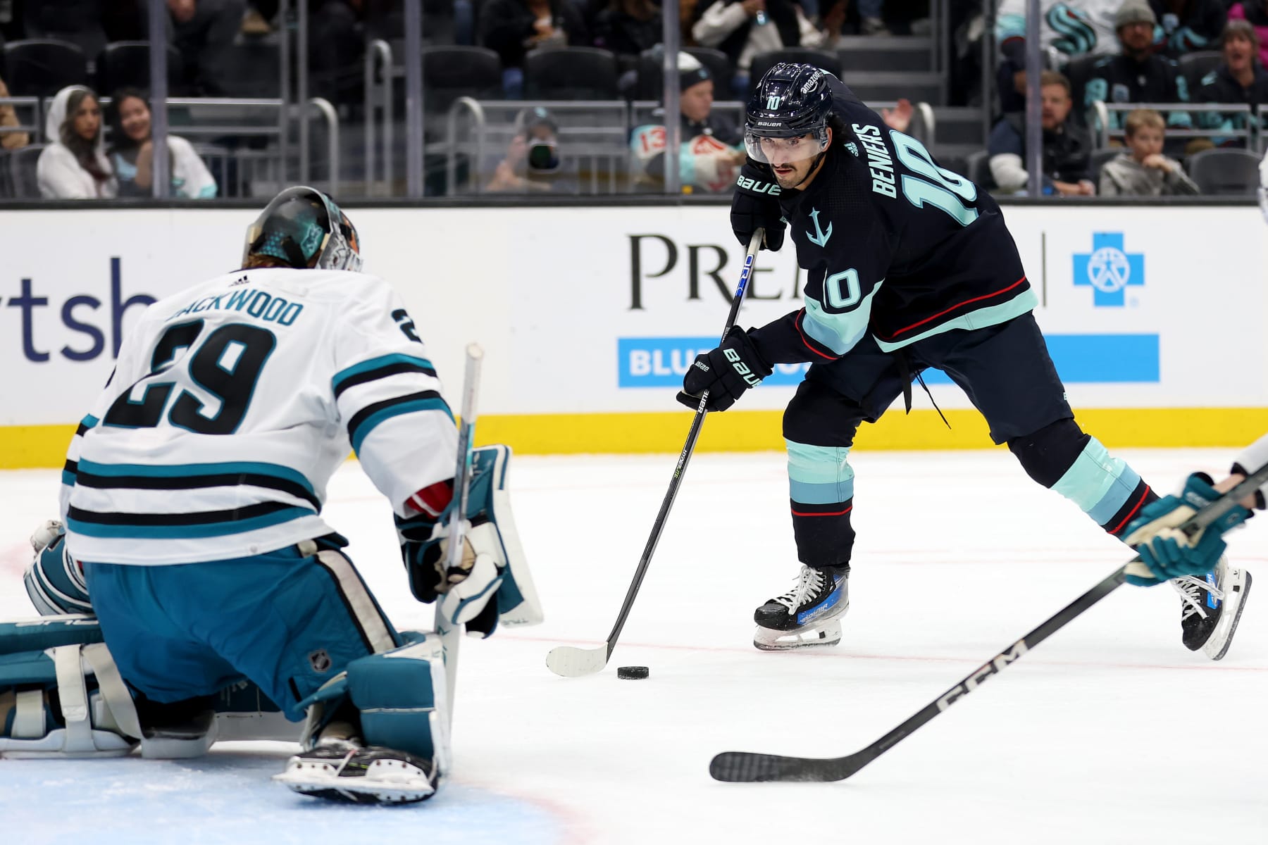 SEATTLE, WASHINGTON - NOVEMBER 22: Matty Beniers #10 of the Seattle Kraken looks to shoot against Mackenzie Blackwood #29 of the San Jose Sharks during the second period at Climate Pledge Arena on November 22, 2023 in Seattle, Washington. (Photo by Steph Chambers/Getty Images)