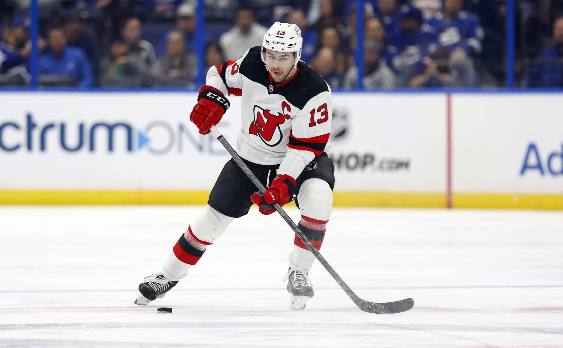 TAMPA, FLORIDA - JANUARY 11: Nico Hischier #13 of the New Jersey Devils looks to pass during a game against the Tampa Bay Lightning at Amalie Arena on January 11, 2024 in Tampa, Florida. (Photo by Mike Ehrmann/Getty Images)