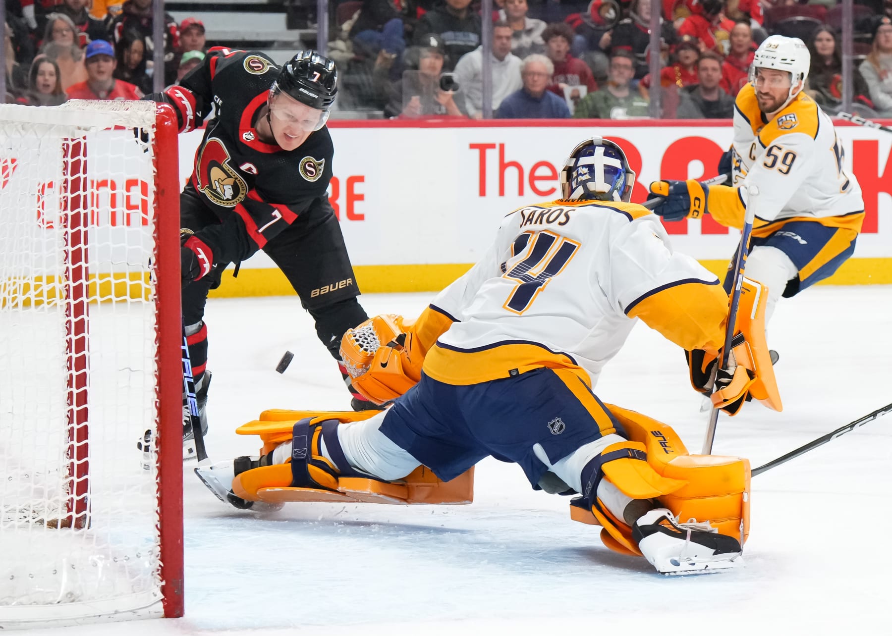 OTTAWA, CANADA - JANUARY 29: Juuse Saros #74 of the Nashville Predators makes a save against Brady Tkachuk #7 of the Ottawa Senators during the first period at Canadian Tire Centre on January 29, 2024 in Ottawa, Ontario, Canada. (Photo by André Ringuette/NHLI via Getty Images)