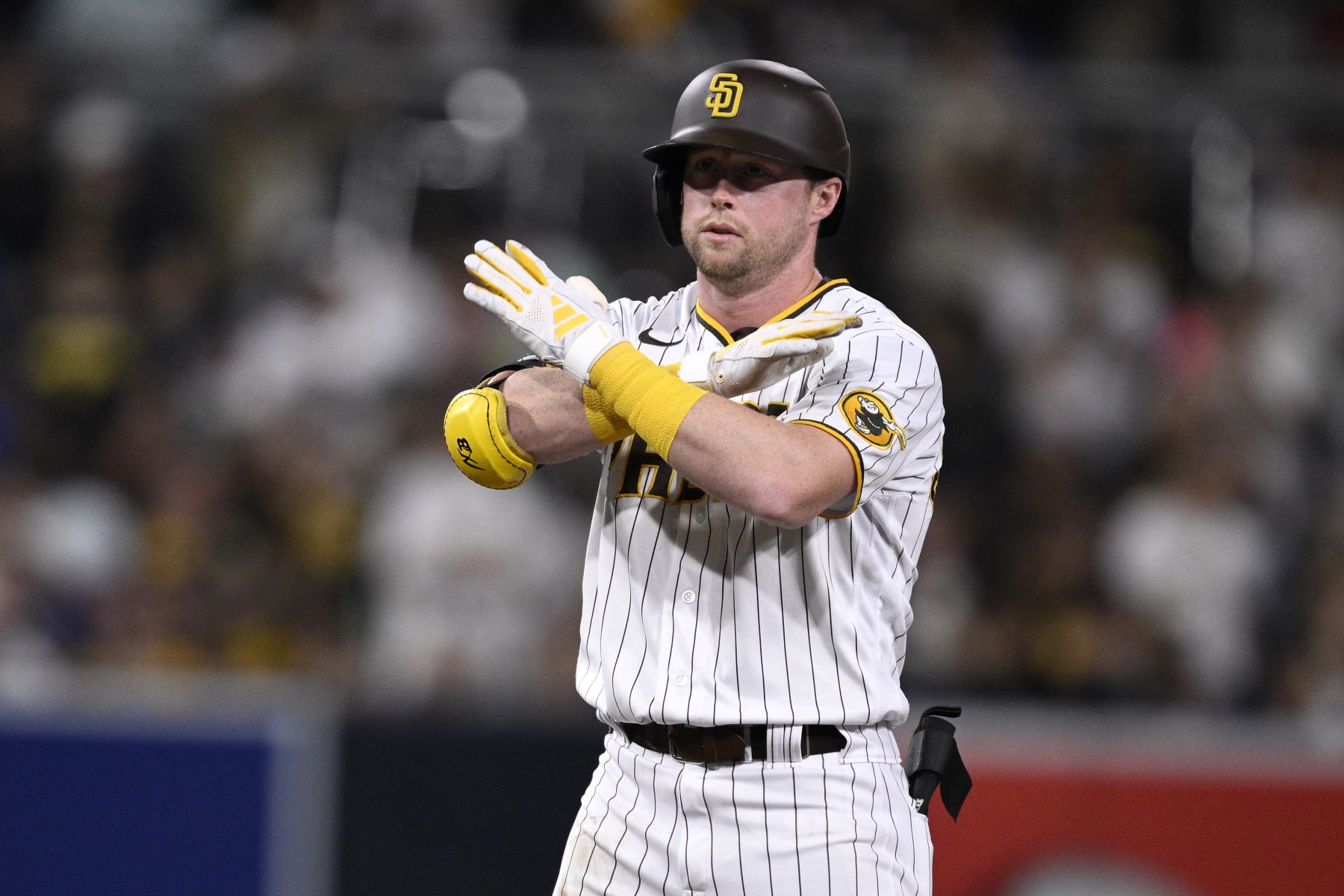 SAN DIEGO, CALIFORNIA - AUGUST 17: Jake Cronenworth #9 of the San Diego Padres gestures after hitting a double against the Arizona Diamondbacks during the fifth inning at PETCO Park on August 17, 2023 in San Diego, California. (Photo by Orlando Ramirez/Getty Images)