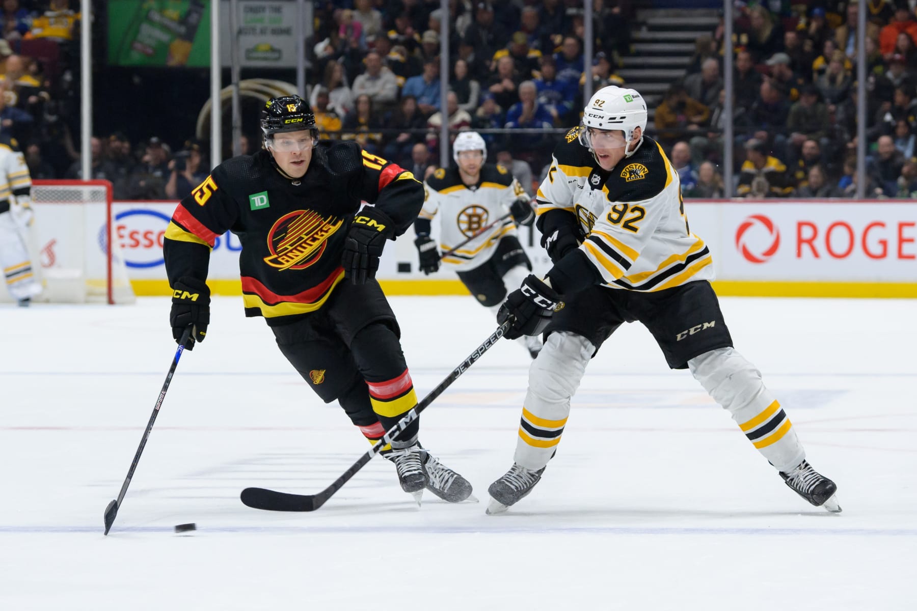 VANCOUVER, CANADA - FEBRUARY 25: Sheldon Dries #15 of the Vancouver Canucks defends against Tomas Nosek #92 of the Boston Bruins during the second period of their NHL game at Rogers Arena on February 25, 2023 in Vancouver, British Columbia, Canada. (Photo by Derek Cain/Getty Images)
