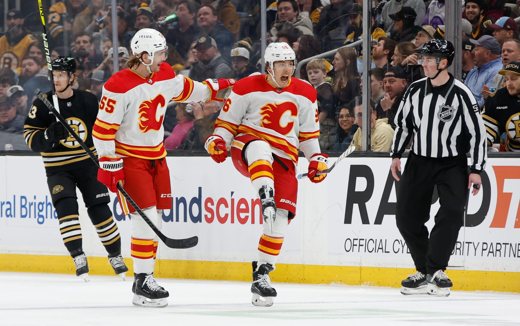 BOSTON, MASSACHUSETTS - FEBRUARY 6: Andrei Kuzmenko #96 of the Calgary Flames celebrates his goal with Noah Hanifin #55 against the Boston Bruins during the first period at the TD Garden on February 6, 2024 in Boston, Massachusetts. (Photo by Rich Gagnon/Getty Images)