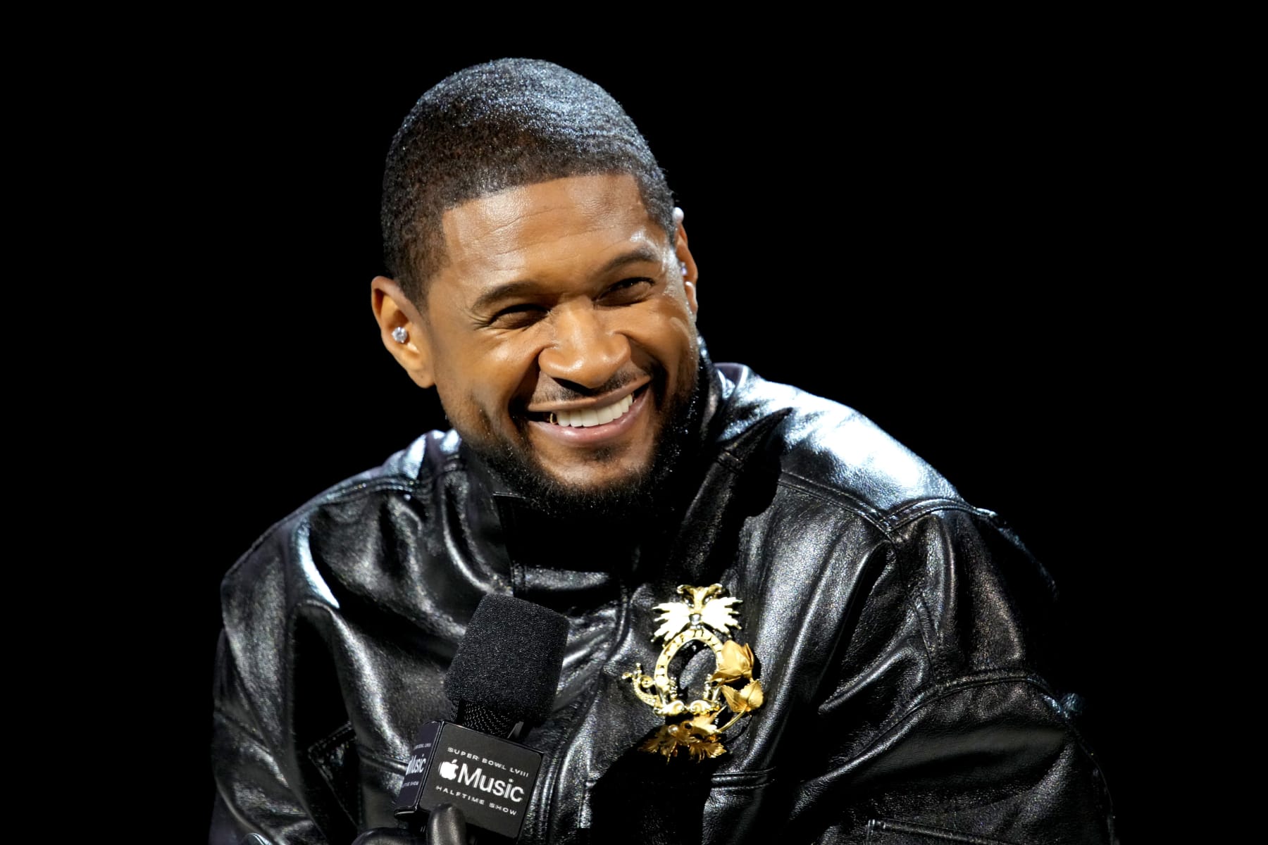 LAS VEGAS, NEVADA - FEBRUARY 08: Usher speaks onstage during the Super Bowl LVIII Pregame & Apple Music Super Bowl LVIII Halftime Show Press Conference at the Mandalay Bay Convention Center on February 08, 2024 in Las Vegas, Nevada. (Photo by Jeff Kravitz/FilmMagic)