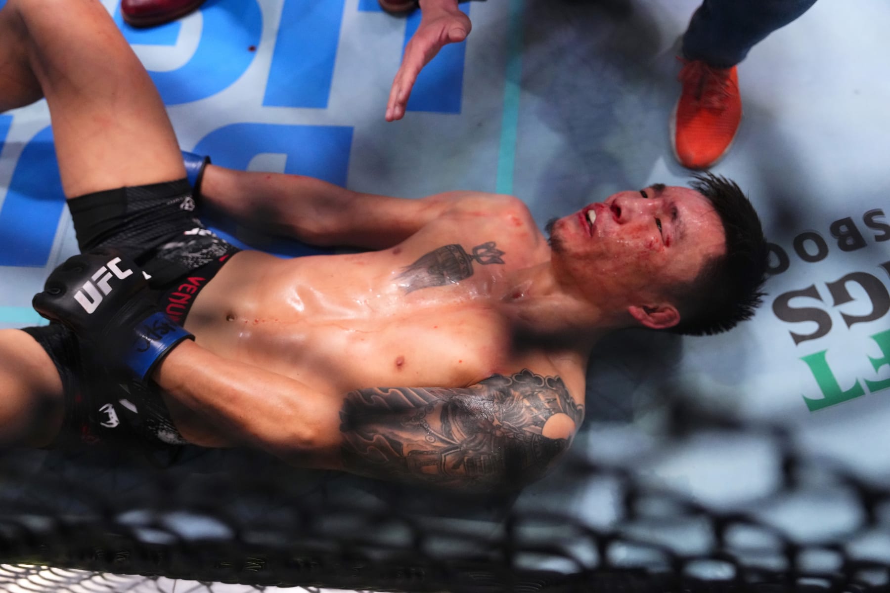 LAS VEGAS, NEVADA - FEBRUARY 10: Aoriqileng of China is unable to continue after an accidental low-blow from Daniel Marcos of Peru in a bantamweight fight during the UFC Fight Night event at UFC APEX on February 10, 2024 in Las Vegas, Nevada. (Photo by Jeff Bottari/Zuffa LLC via Getty Images)