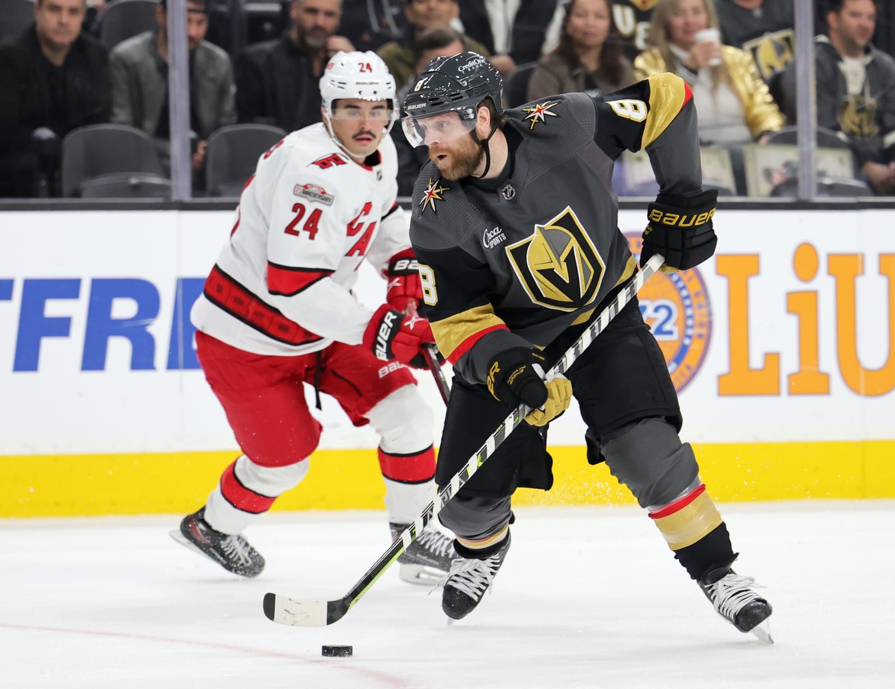 LAS VEGAS, NEVADA - MARCH 01: Phil Kessel #8 of the Vegas Golden Knights skates with the puck ahead of Seth Jarvis #24 of the Carolina Hurricanes in the second period of their game at T-Mobile Arena on March 01, 2023 in Las Vegas, Nevada. The Golden Knights defeated the Hurricanes 3-2. (Photo by Ethan Miller/Getty Images)