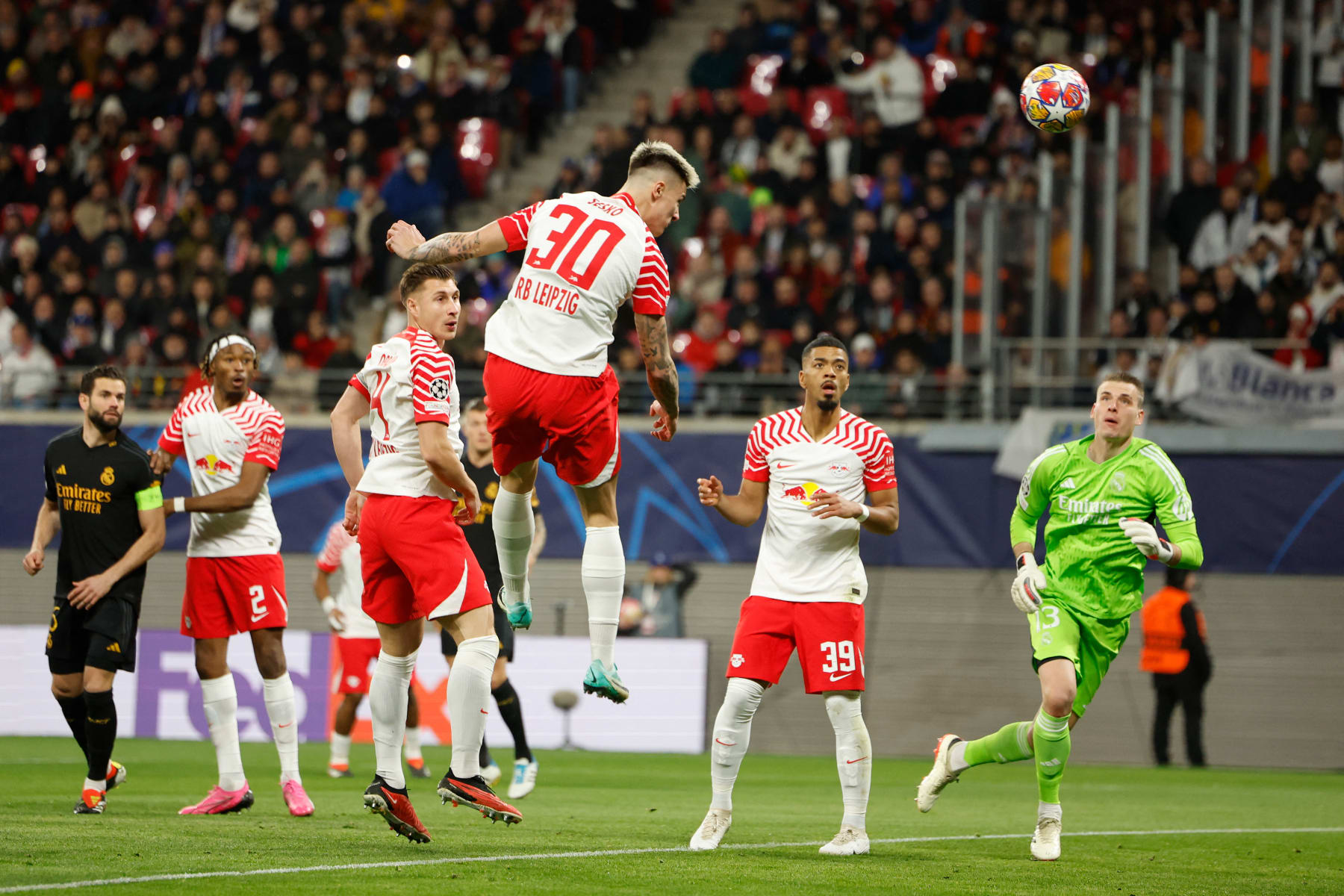 Leipzig's Slovenian forward #30 Benjamin Sesko heads the ball to score a goal which was offside during the UEFA Champions League Round of 16, first-leg football match between RB Leipzig and Real Madrid CF in Leipzig, eastern Germany, on February 13, 2024. (Photo by Odd ANDERSEN / AFP) (Photo by ODD ANDERSEN/AFP via Getty Images)