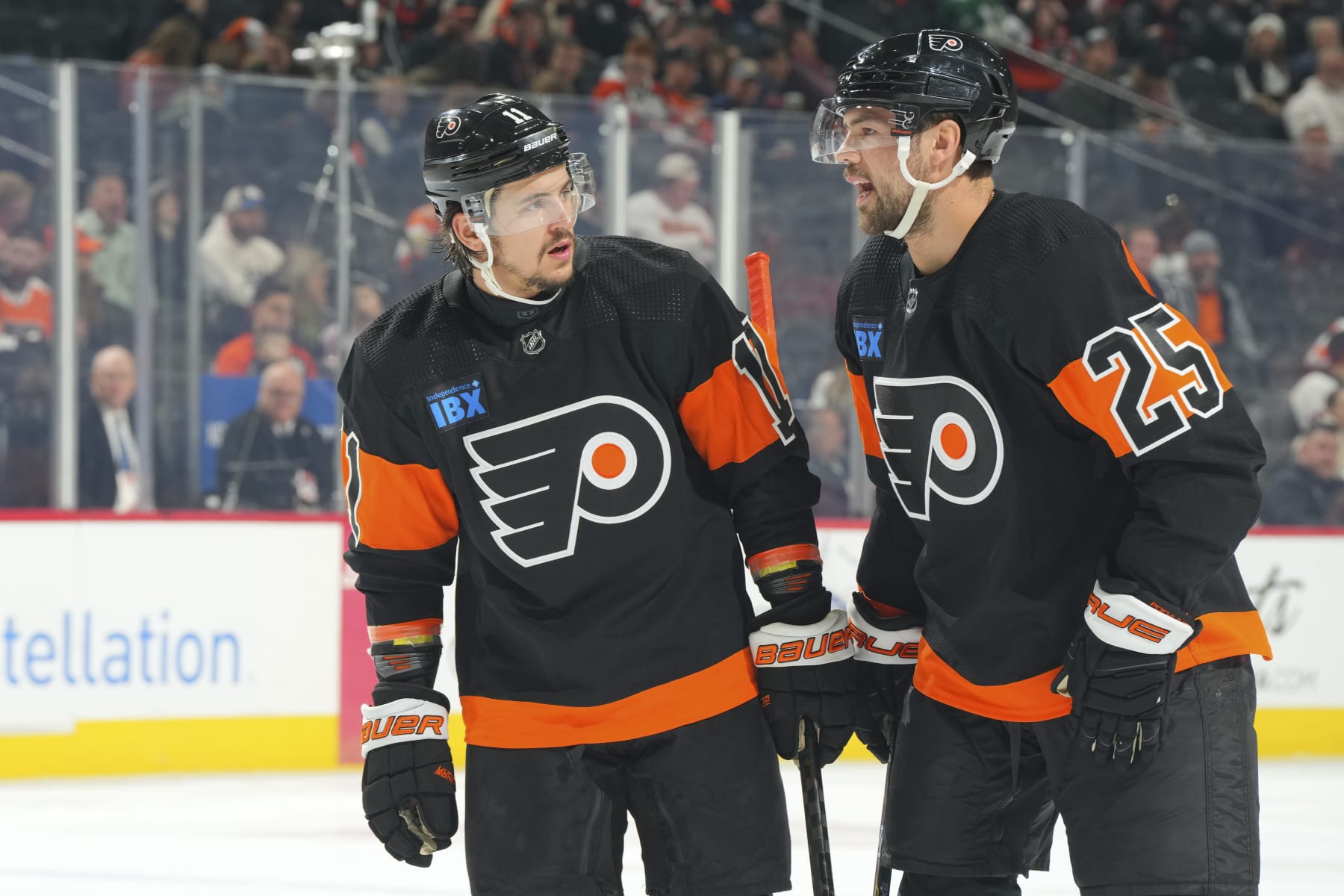 PHILADELPHIA, PENNSYLVANIA - FEBRUARY 12: Travis Konecny #11 of the Philadelphia Flyers talks to Ryan Poehling #25 against the Arizona Coyotes at the Wells Fargo Center on February 12, 2024 in Philadelphia, Pennsylvania. The Flyers defeated the Coyotes 5-3. (Photo by Mitchell Leff/Getty Images)