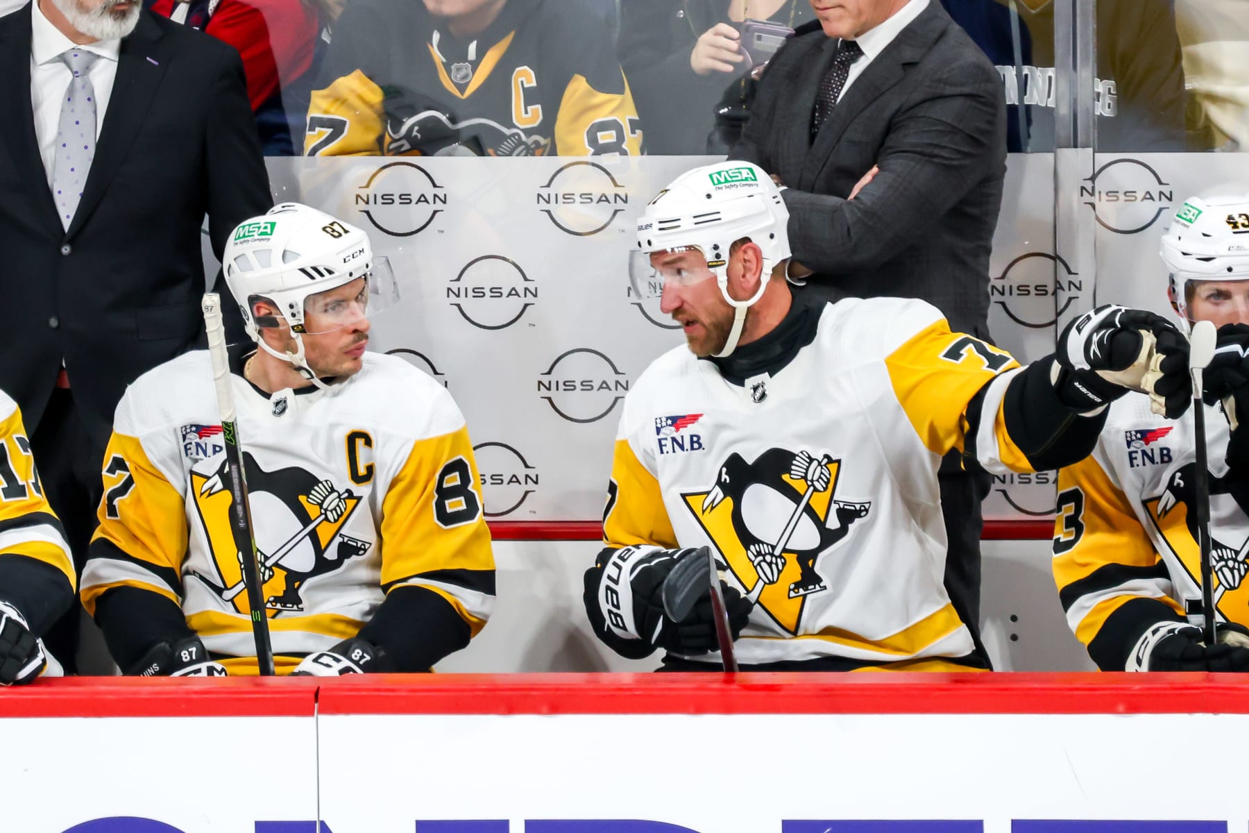 WINNIPEG, CANADA - FEBRUARY 10: Sidney Crosby #87 and Jeff Carter #77 of the Pittsburgh Penguins discuss strategy on the bench during second period action against the Winnipeg Jets at the Canada Life Centre on February 10, 2024 in Winnipeg, Manitoba, Canada. (Photo by Jonathan Kozub/NHLI via Getty Images)