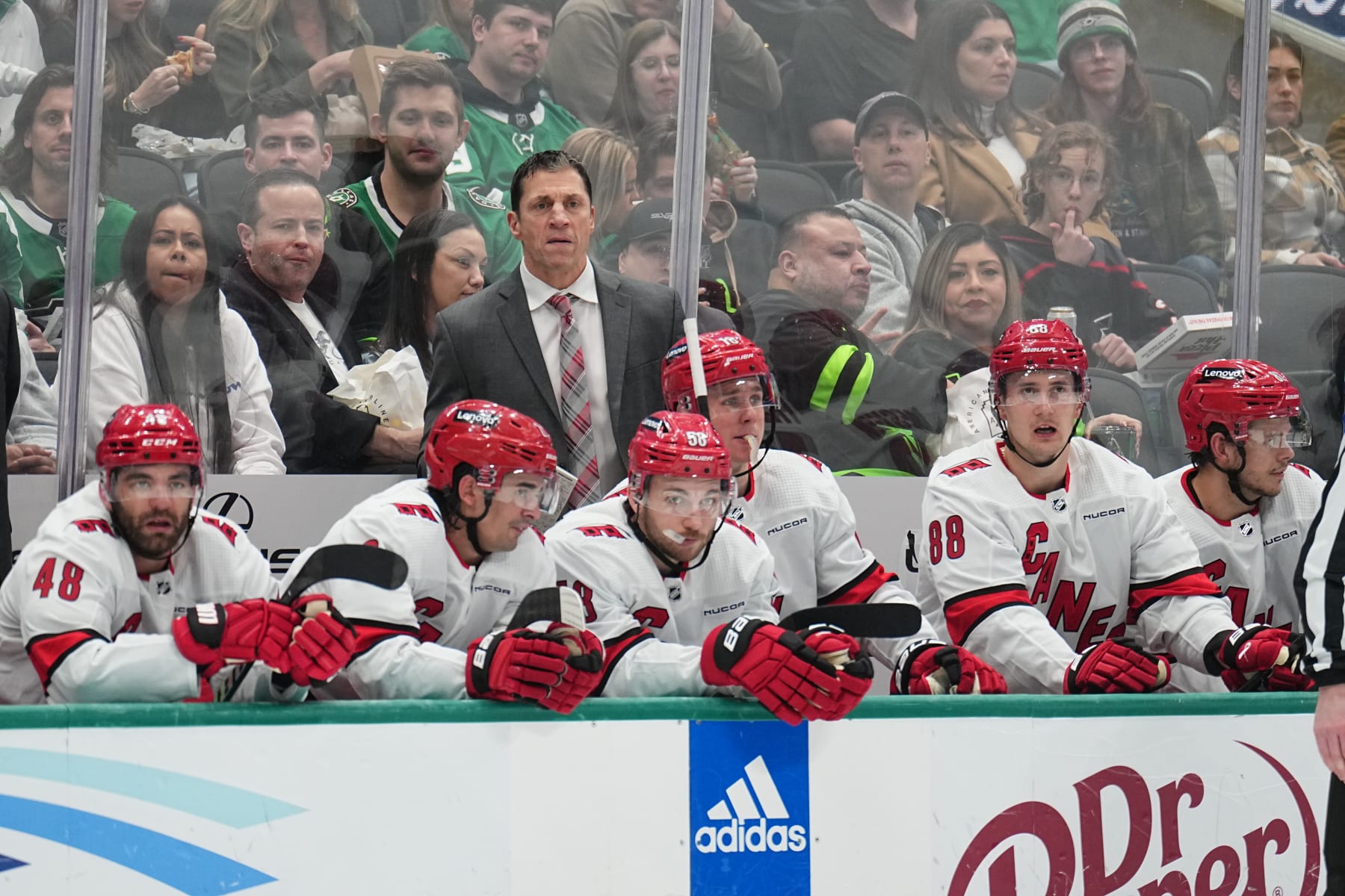 DALLAS, TX - FEBRUARY 13: Rod Brind'Amour watches the action from behind the bench against the Dallas Stars at the American Airlines Center on February 13, 2024 in Dallas, Texas. (Photo by Glenn James/NHLI via Getty Images)