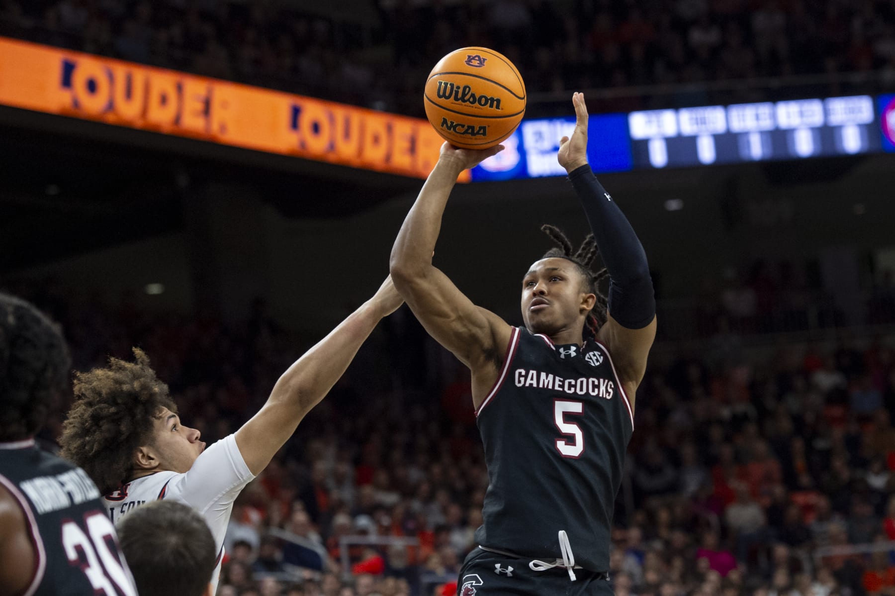 AUBURN, ALABAMA - FEBRUARY 14: Meechie Johnson #5 of the South Carolina Gamecocks looks to take a shot over Tre Donaldson #3 of the Auburn Tigers during the first half of play at Neville Arena on February 14, 2024 in Auburn, Alabama. (Photo by Michael Chang/Getty Images)