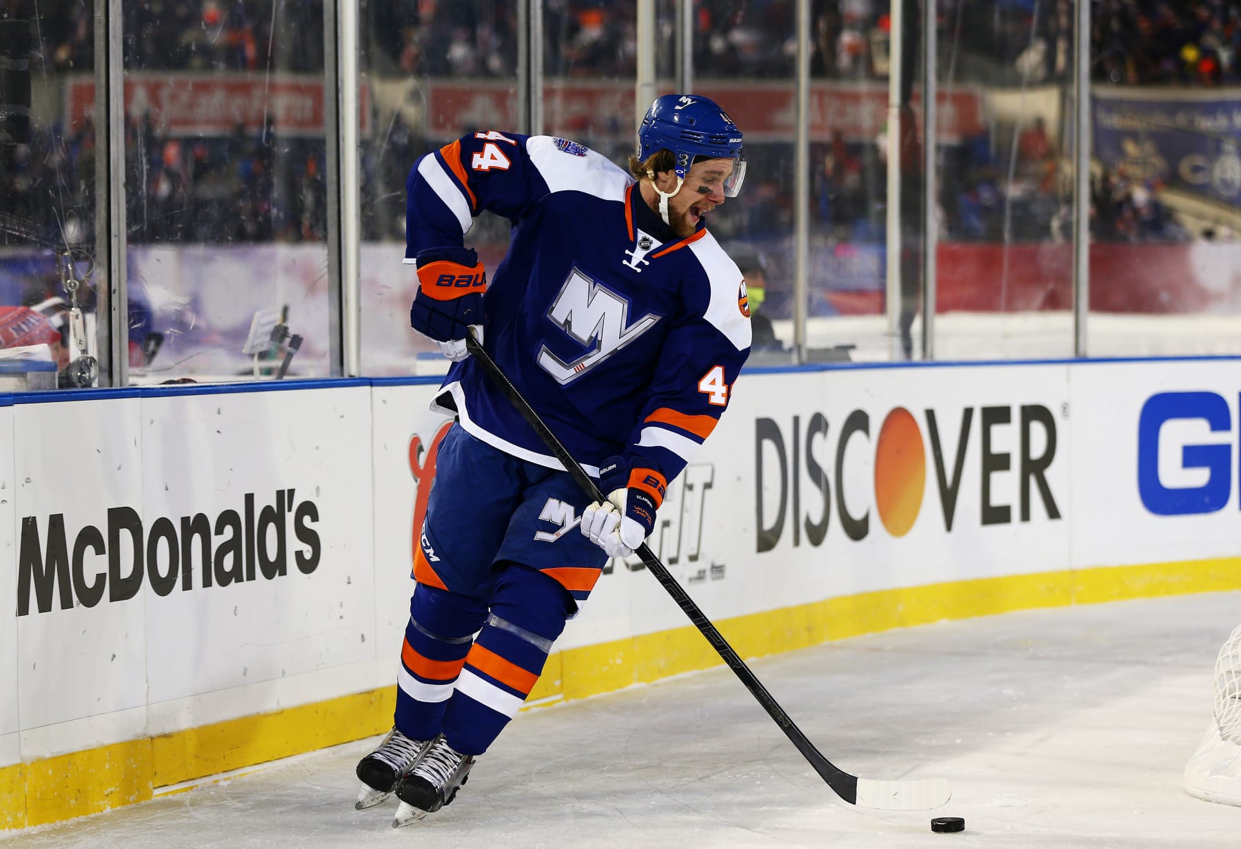NEW YORK, NY - JANUARY 29: (EDITORIAL USE ONLY) Calvin de Haan #44 of the New York Islanders controls the puck against the New York Rangers during the 2014 Coors Light NHL Stadium Series at Yankee Stadium on January 29, 2014 in New York City. (Photo by Elsa/Getty Images)