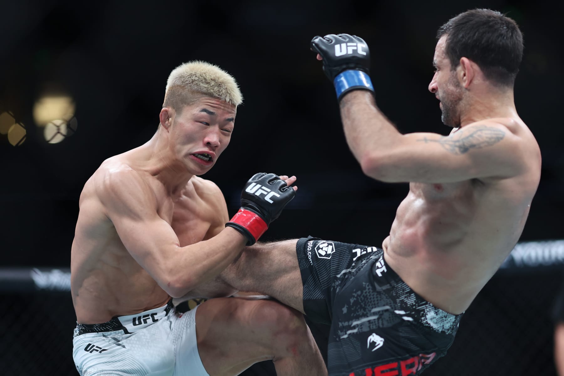 ANAHEIM, CALIFORNIA - FEBRUARY 17: Rinya Nakamura of Japan exchanges strikes with Carlos Vera in their bantamweight fight during UFC 298 at Honda Center on February 17, 2024 in Anaheim, California. (Photo by Sean M. Haffey/Getty Images)