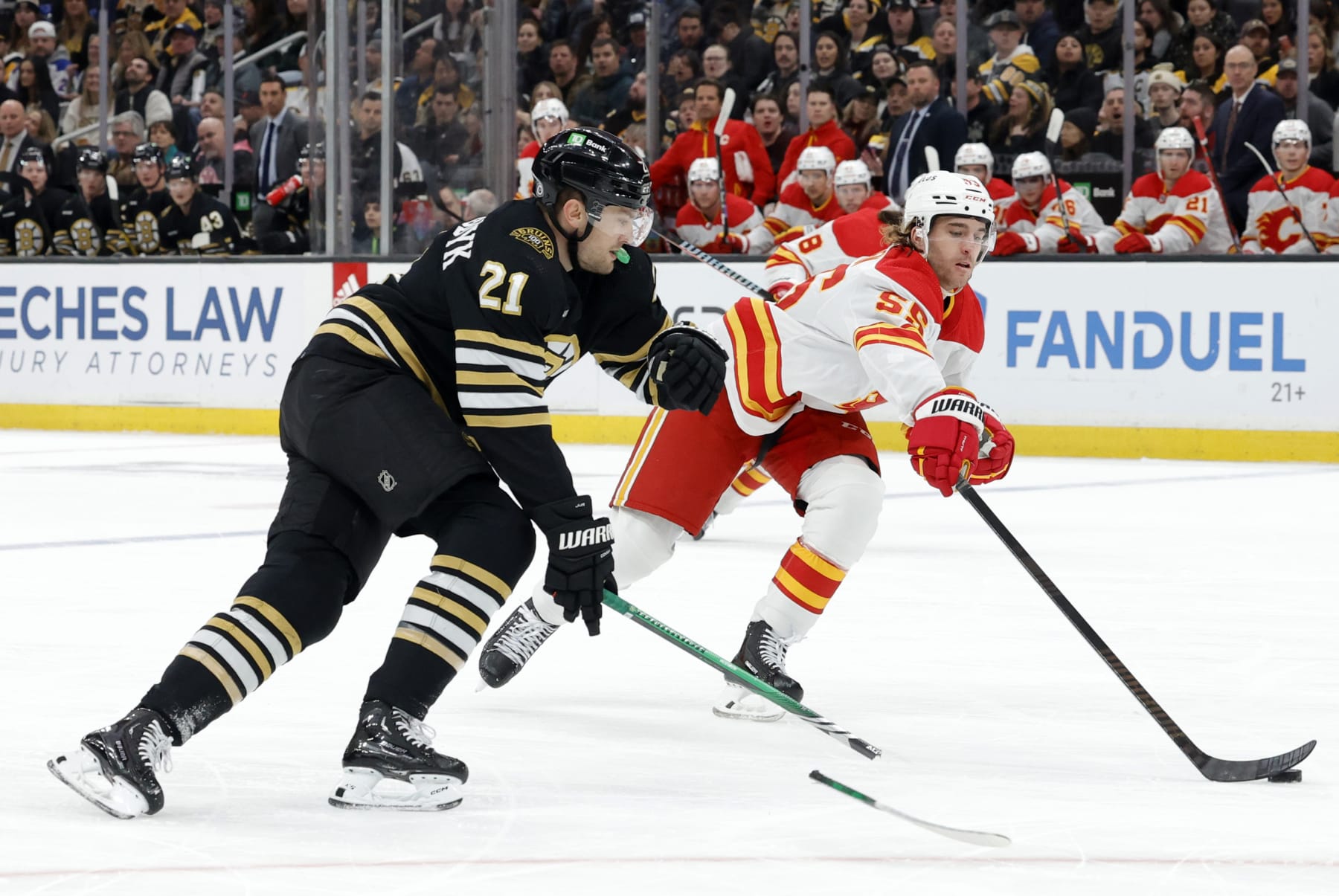 BOSTON, MA - FEBRUARY 06: Calgary Flames defenseman Noah Hanifin (55) takes advantage of the broken stick of Boston Bruins left wing James van Riemsdyk (21) during a game between the Boston Bruins and the Calgary Flames on February 6, 2024, at TD Garden in Boston, Massachusetts. (Photo by Fred Kfoury III/Icon Sportswire via Getty Images)