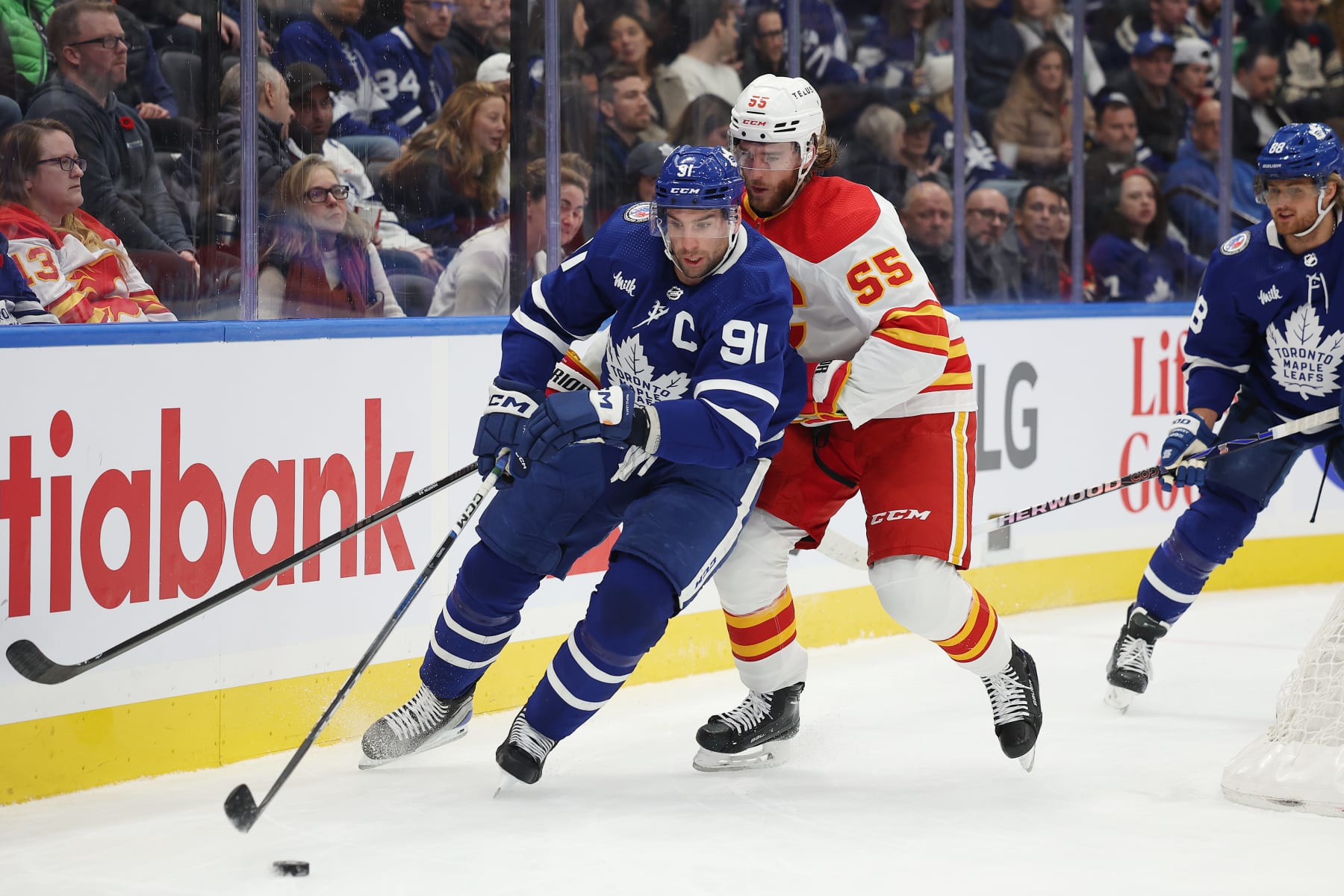 TORONTO: Toronto Maple Leafs John Tavares( 91 blue) circles around the back of the net with Noah Hanifin ( 55) white) of the Calgary Flames in tow in NHL action on Friday .(R.J.Johnston/Toronto Star)
(R.J. Johnston Toronto Star/Toronto Star via Getty Images)
