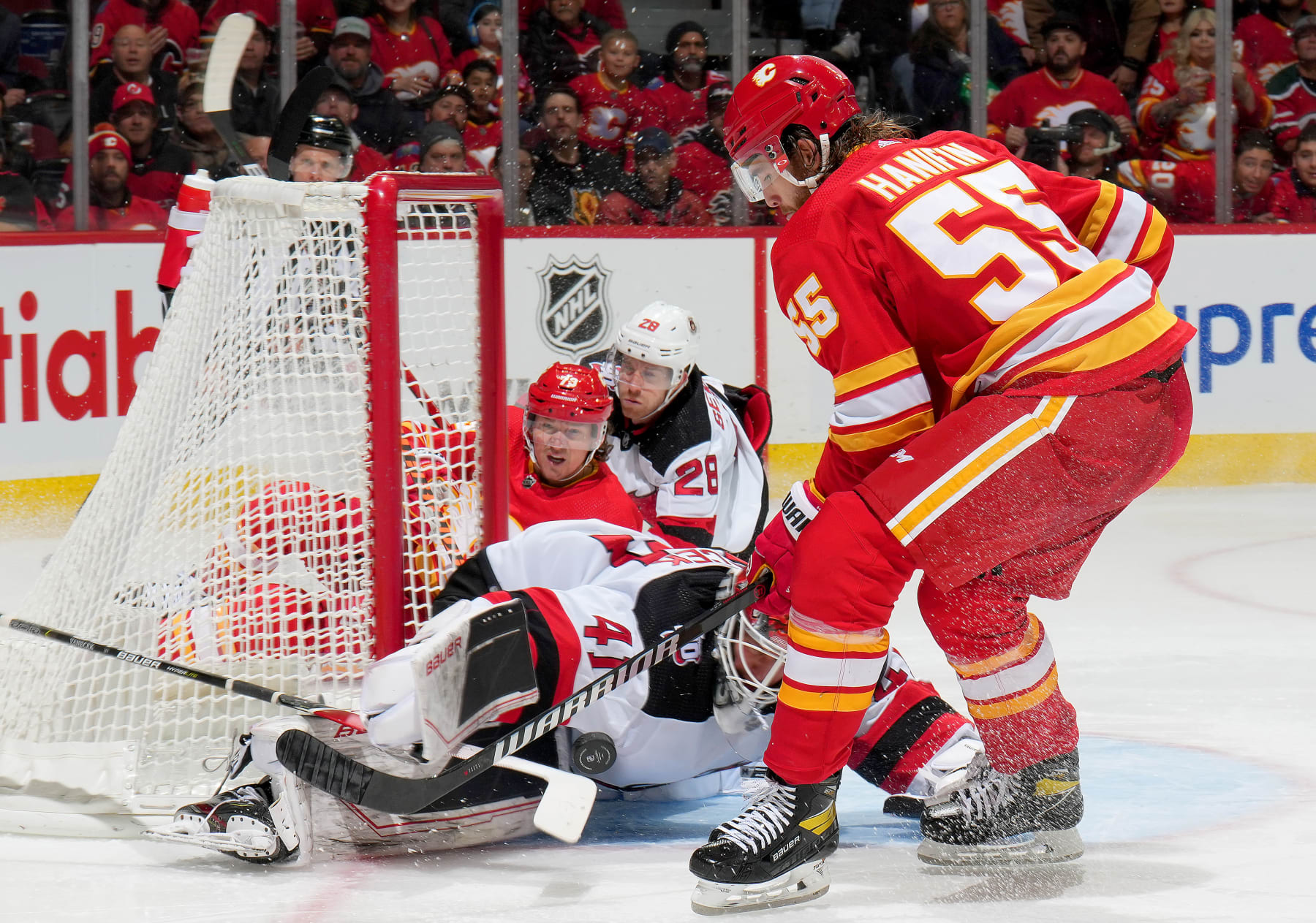 CALGARY, ALBERTA - NOVEMBER 05: Noah Hanifin #55 of the Calgary Flames shoots the puck against Vitek Vanecek #41 of the New Jersey Devils at Scotiabank Saddledome on November 05, 2022 in Calgary, Alberta. (Photo by Gerry Thomas/NHLI via Getty Images)