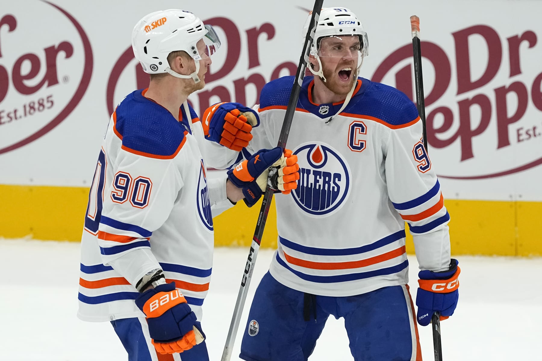 DALLAS, TEXAS - FEBRUARY 17: Connor McDavid #97 of the Edmonton Oilers celebrates with Corey Perry #90 after defeating the Dallas Stars in overtime at American Airlines Center on February 17, 2024 in Dallas, Texas. (Photo by Sam Hodde/Getty Images)