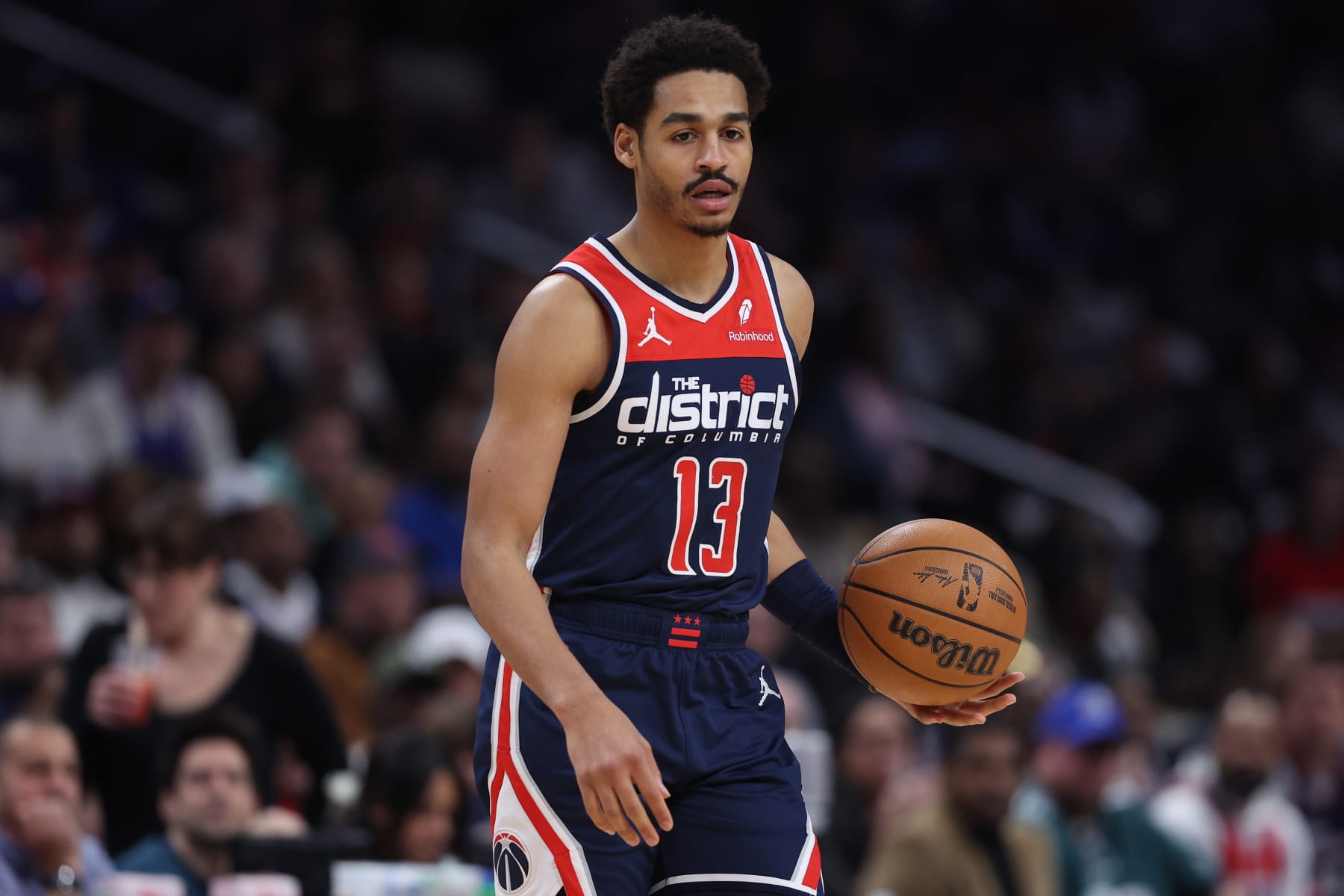 WASHINGTON, DC - FEBRUARY 10: Jordan Poole #13 of the Washington Wizards dribbles the ball against the Philadelphia 76ers during the first half at Capital One Arena on February 10, 2024 in Washington, DC. NOTE TO USER: User expressly acknowledges and agrees that, by downloading and or using this photograph, User is consenting to the terms and conditions of the Getty Images License Agreement.  (Photo by Patrick Smith/Getty Images)