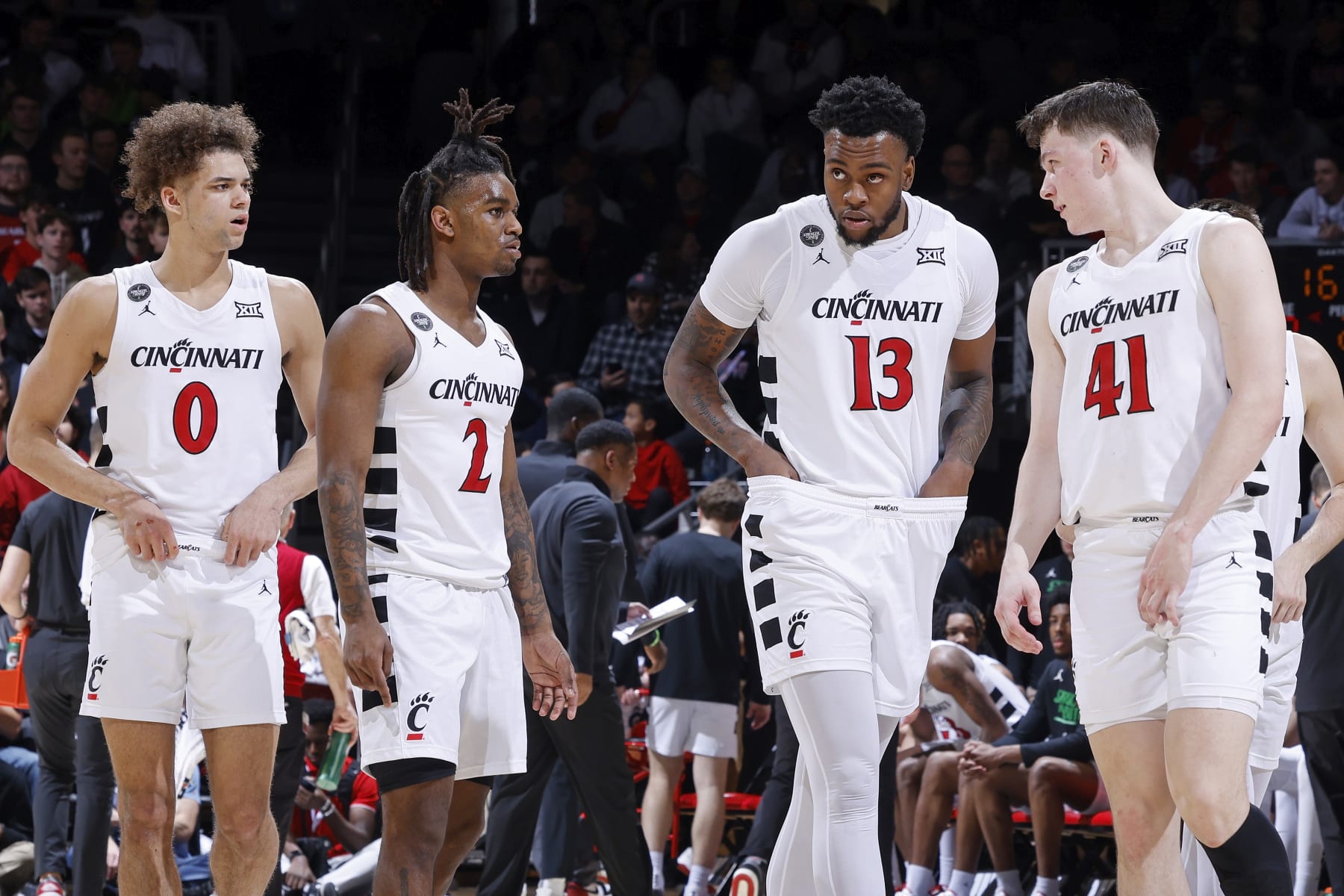 CINCINNATI, OH - FEBRUARY 13: Cincinnati Bearcats guard Dan Skillings Jr. (0), guard Jizzle James (2), forward Jamille Reynolds (13) and guard Simas Lukosius (41) look on during a college basketball game against the Iowa State Cyclones on February 13, 2024 at Fifth Third Arena in Cincinnati, Ohio. (Photo by Joe Robbins/Icon Sportswire via Getty Images)