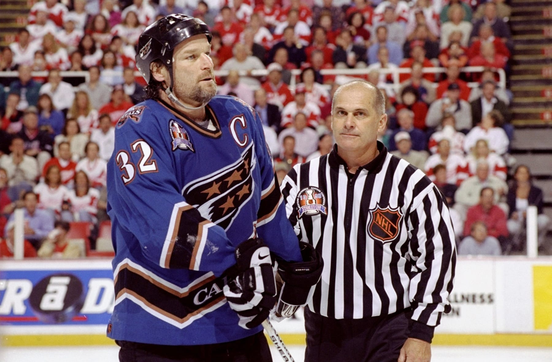 9 Jun 1998: Dale Hunter #32 of the Washington Capitals iis escorted off by a referee during the NHL Stanley Cup Finals game against the Detroit Red Wings at the Joe Louis Arena in Detroit, Michigan. The Red Wings defeated the Capitals 2-1. Mandatory Credit: Elsa Hasch /Allsport