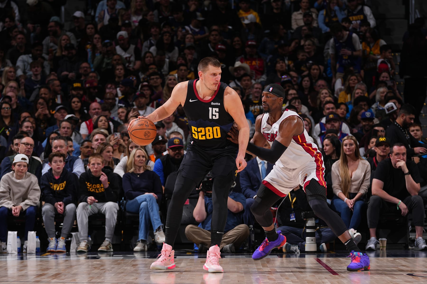 DENVER, CO - FEBRUARY 29: Nikola Jokic #15 of the Denver Nuggets handles the ball against Bam Adebayo #13 of the Miami Heat during the game on February 29, 2024 at the Ball Arena in Denver, Colorado. NOTE TO USER: User expressly acknowledges and agrees that, by downloading and/or using this Photograph, user is consenting to the terms and conditions of the Getty Images License Agreement. Mandatory Copyright Notice: Copyright 2024 NBAE (Photo by Bart Young/NBAE via Getty Images)