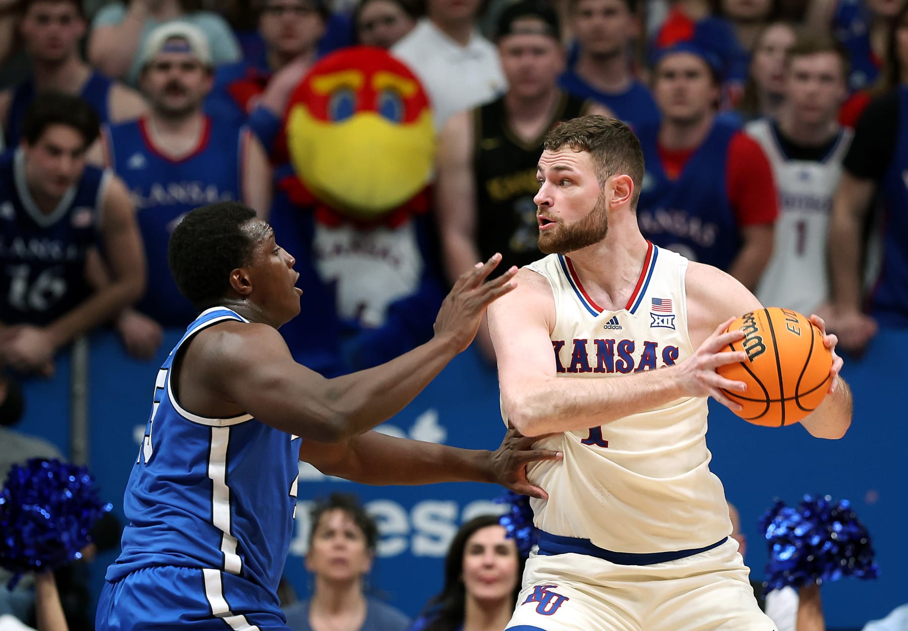 LAWRENCE, KANSAS - FEBRUARY 27: Hunter Dickinson #1 of the Kansas Jayhawks controls the ball as Fousseyni Traore #45 of the Brigham Young Cougars defends during the 2nd half of the game at Allen Fieldhouse on February 27, 2024 in Lawrence, Kansas. (Photo by Jamie Squire/Getty Images)