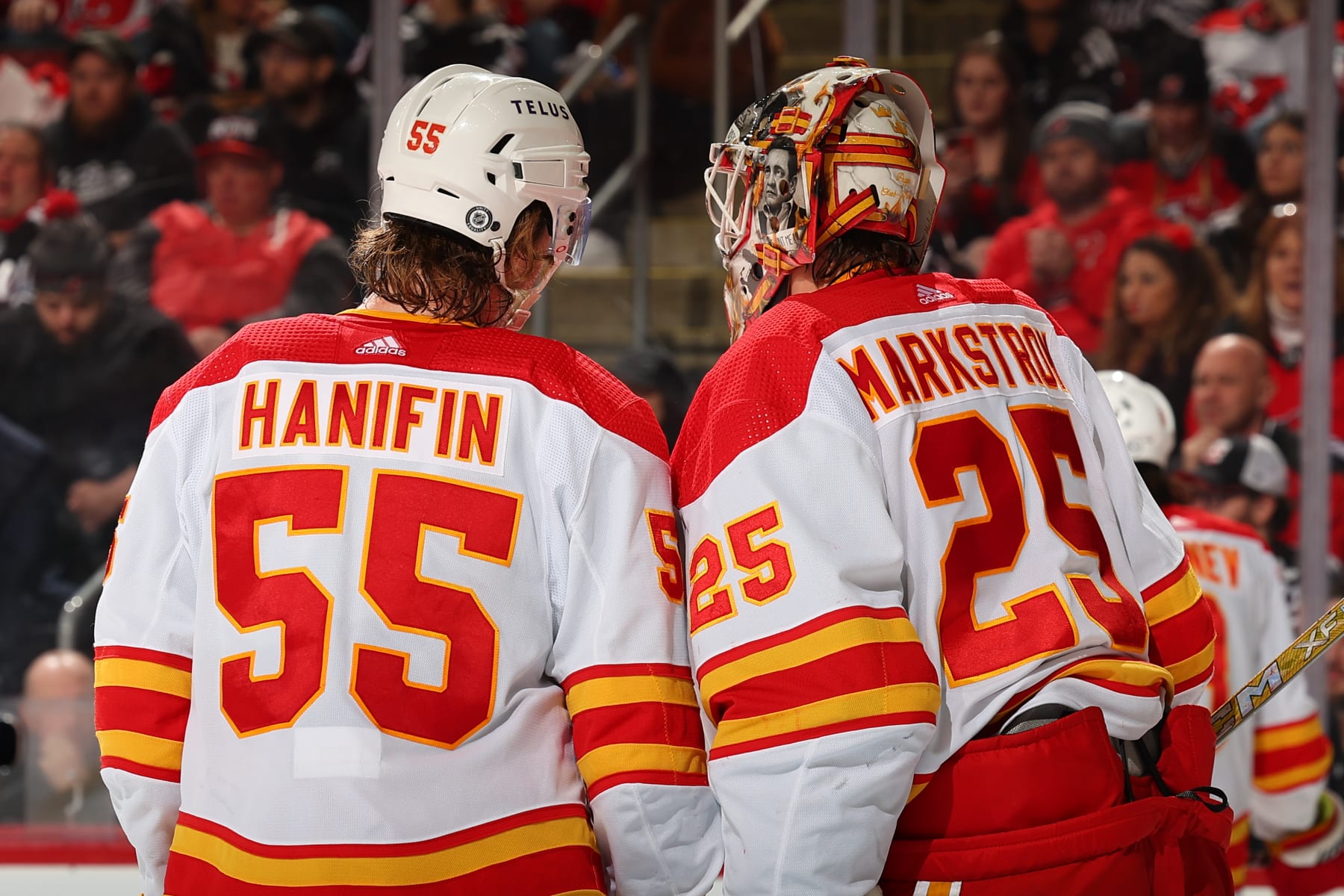 NEWARK, NJ - FEBRUARY 08: Noah Hanifin #55 of the Calgary Flames and Jacob Markstrom #25 during the third period of the game against the New Jersey Devils at the Prudential Center on February 8, 2024 in Newark, New Jersey. (Photo by Rich Graessle/NHLI via Getty Images)