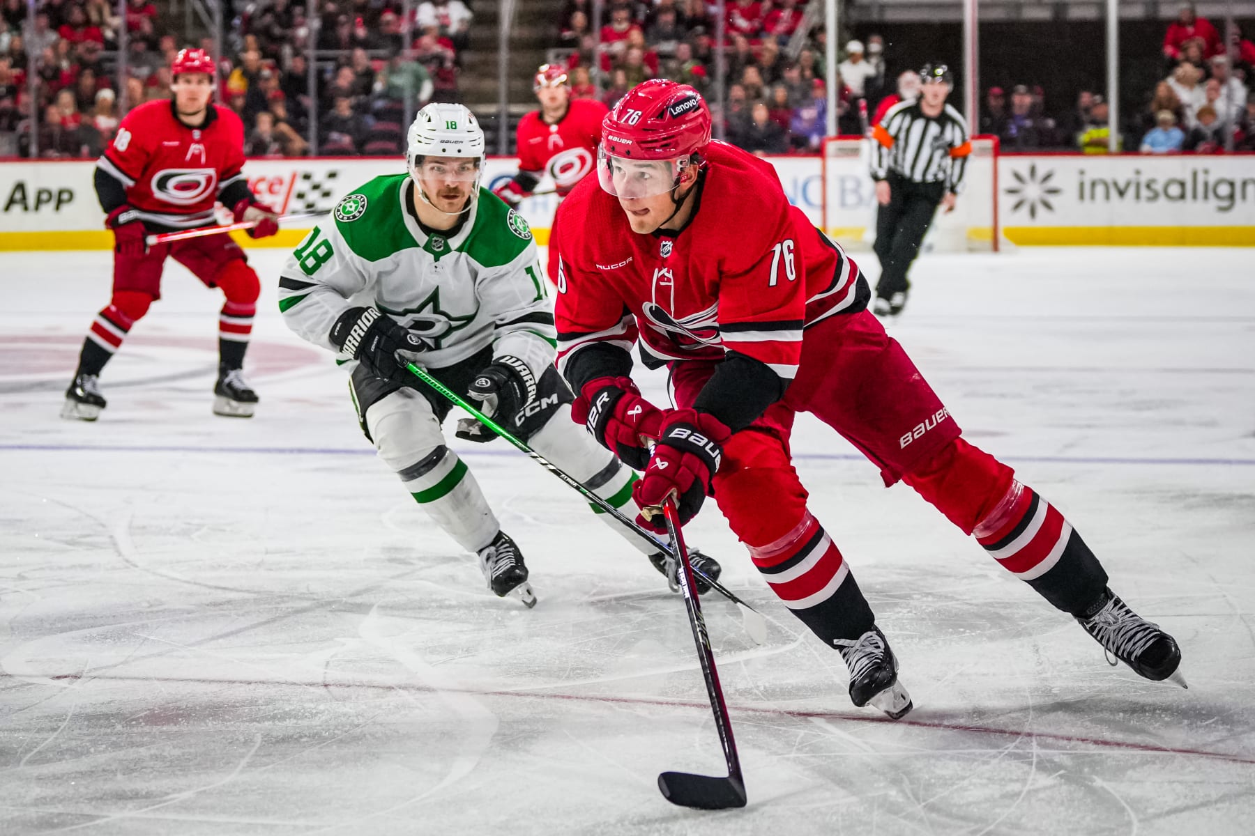 RALEIGH, NORTH CAROLINA - FEBRUARY 24: Brady Skjei #76 of the Carolina Hurricanes skates with the puck against Sam Steel #18 of the Dallas Stars during the third period at PNC Arena on February 24, 2024 in Raleigh, North Carolina. (Photo by Josh Lavallee/NHLI via Getty Images)