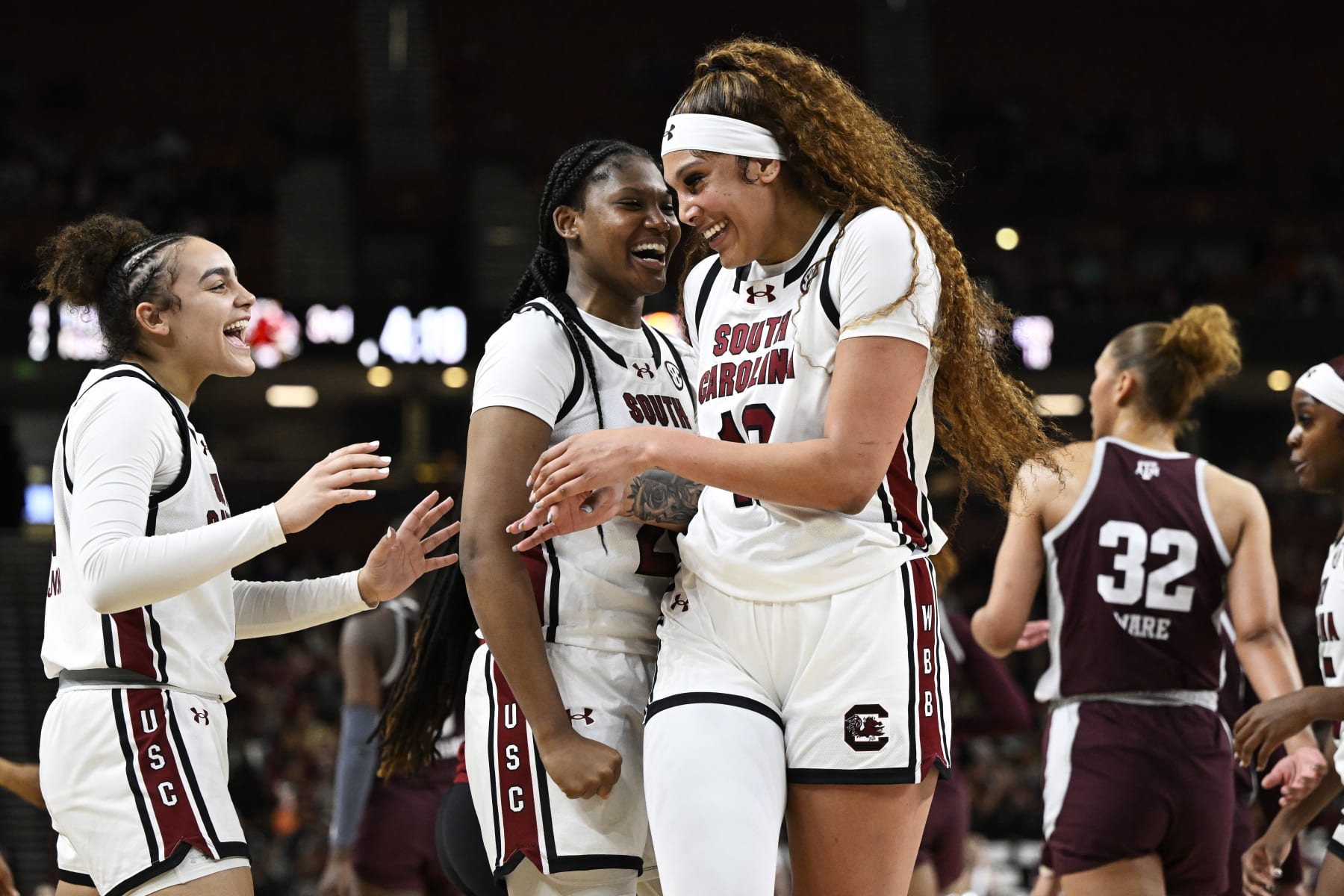 GREENVILLE, SOUTH CAROLINA - MARCH 08: Kamilla Cardoso #10, Sania Feagin #20, and Tessa Johnson #5 of the South Carolina Gamecocks celebrate against the Texas A&M Aggies in the third quarter during the quarterfinals of the SEC Women's Basketball Tournament at Bon Secours Wellness Arena on March 08, 2024 in Greenville, South Carolina. (Photo by Eakin Howard/Getty Images)