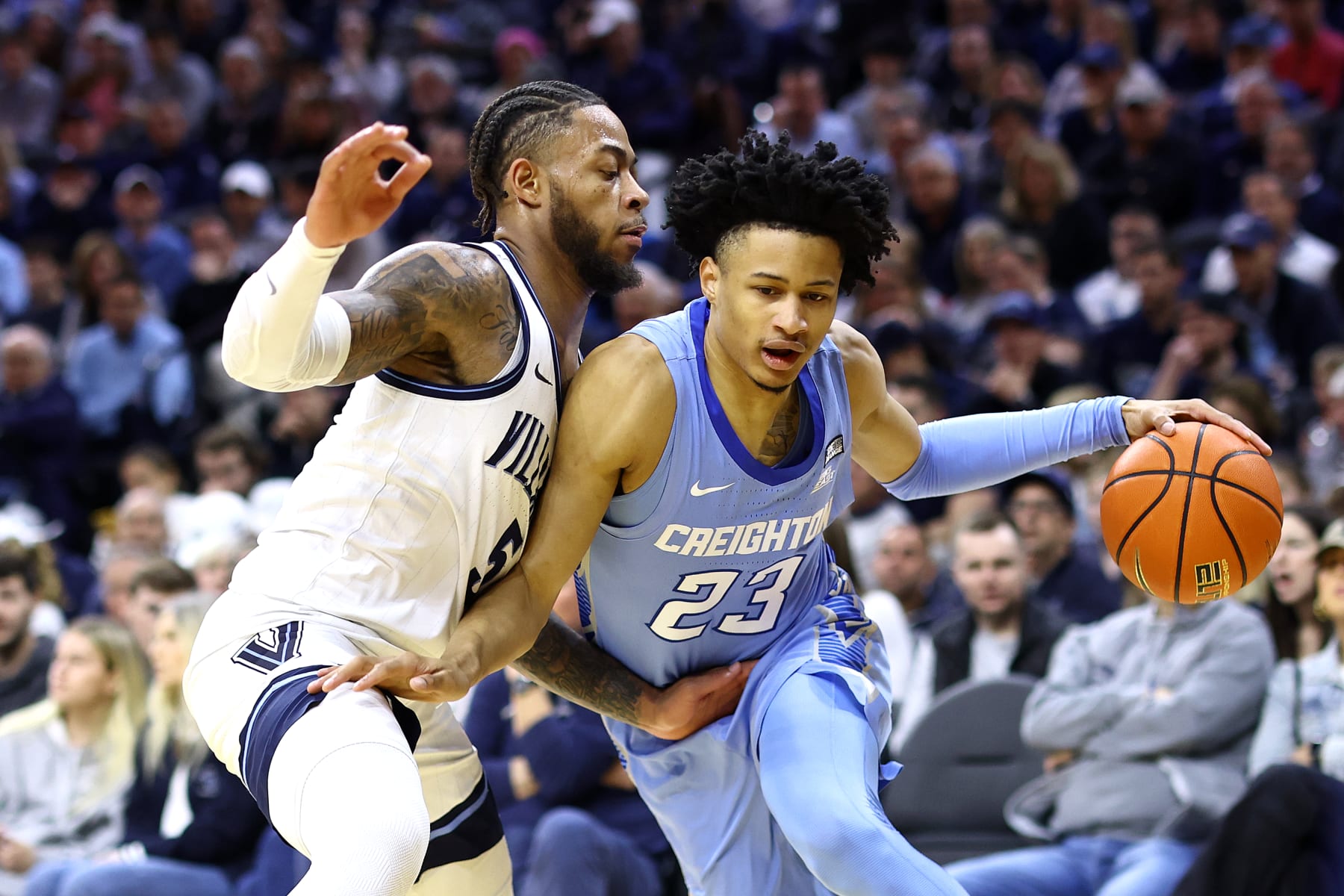 PHILADELPHIA, PENNSYLVANIA - MARCH 09: Trey Alexander #23 of the Creighton Bluejays dribbles by Justin Moore #5 of the Villanova Wildcats during the first half at the Wells Fargo Center on March 09, 2024 in Philadelphia, Pennsylvania. (Photo by Tim Nwachukwu/Getty Images)