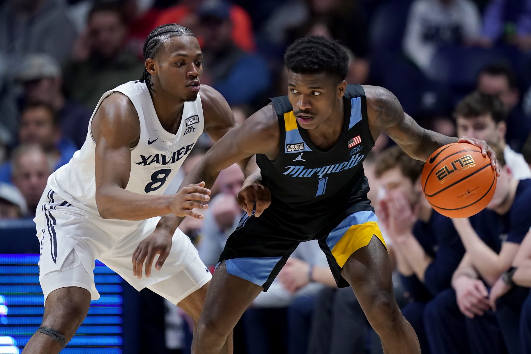 CINCINNATI, OHIO - MARCH 09: Kam Jones #1 of the Marquette Golden Eagles dribbles the ball while being guarded by Quincy Olivari #8 of the Xavier Musketeers in the first half at the Cintas Center on March 09, 2024 in Cincinnati, Ohio. (Photo by Dylan Buell/Getty Images)