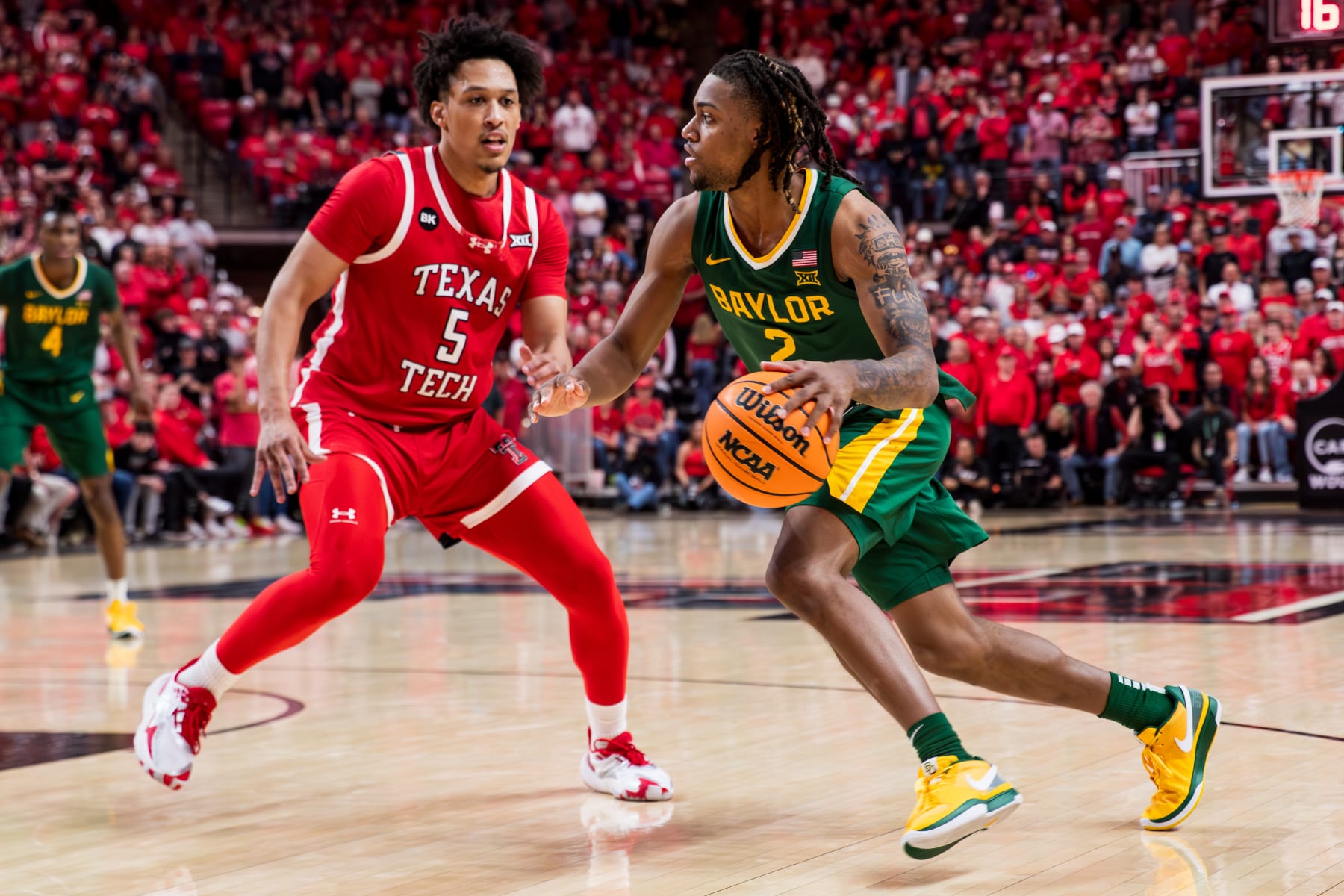 LUBBOCK, TEXAS - MARCH 09: Jayden Nunn #2 of the Baylor Bears handles the ball against Darrion Williams #5 of the Texas Tech Red Raiders during the second half of the game at United Supermarkets Arena on March 09, 2024 in Lubbock, Texas. (Photo by John E. Moore III/Getty Images)
