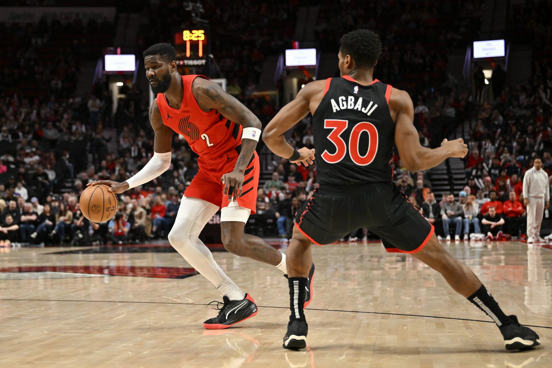 PORTLAND, OREGON - MARCH 09: Deandre Ayton #2 of the Portland Trail Blazers dribbles past Ochai Agbaji #30 of the Toronto Raptors during the first quarter of the game at the Moda Center on March 09, 2024 in Portland, Oregon. NOTE TO USER: User expressly acknowledges and agrees that, by downloading and or using this photograph, User is consenting to the terms and conditions of the Getty Images License Agreement. (Photo by Alika Jenner/Getty Images)