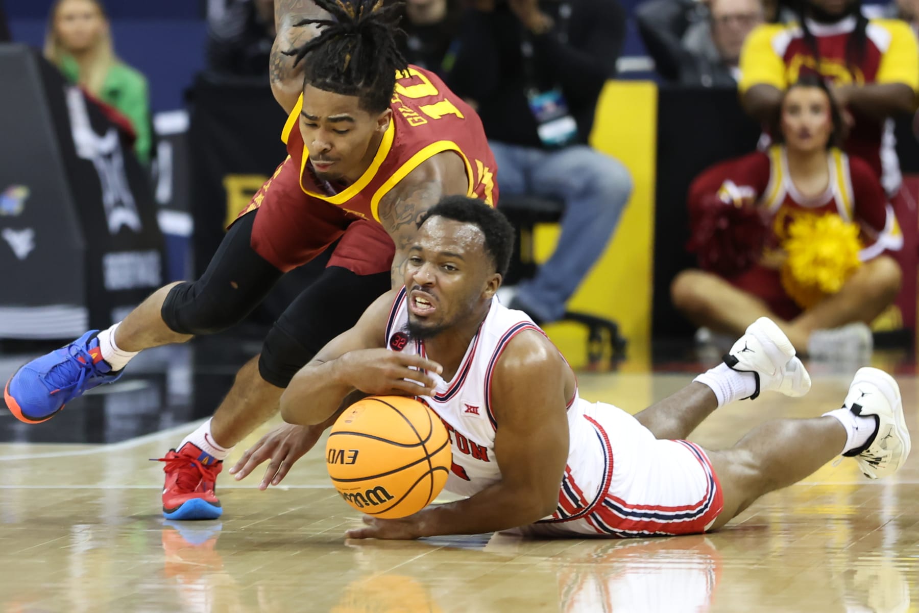 KANSAS CITY, MO - MARCH 16: Houston Cougars guard L.J. Cryer (4) and Iowa State Cyclones guard Keshon Gilbert (10) hit the floor for a loose ball in the first half of the Big 12 tournament final between the Iowa State Cyclones and Houston Cougars on Mar 16, 2024 at T-Mobile Center in Kansas City, MO. (Photo by Scott Winters/Icon Sportswire via Getty Images)