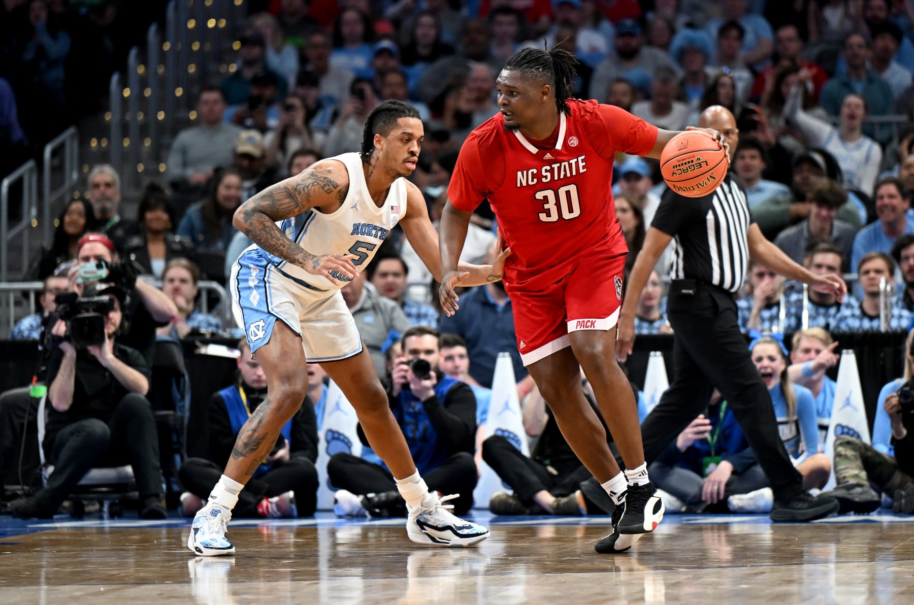 WASHINGTON, DC - MARCH 16: DJ Burns Jr. #30 of the North Carolina State Wolfpack handles the ball in the first half against Armando Bacot #5 of the North Carolina Tar Heels in the Championship Game of the ACC Men's Basketball Tournament at Capital One Arena on March 16, 2024 in Washington, DC. (Photo by Greg Fiume/Getty Images)
